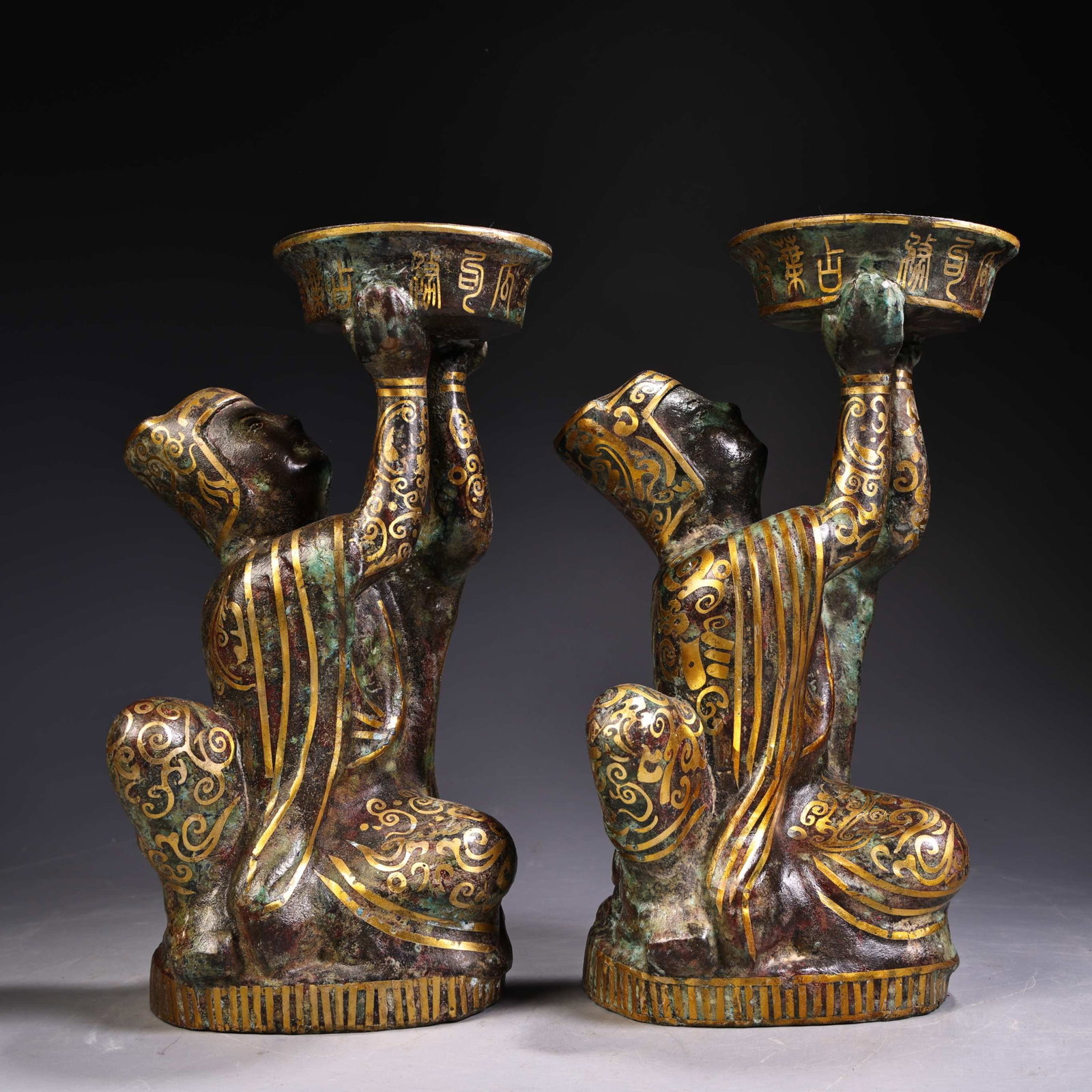 A Pair of Exquisite Bronze Inlaid Gold Figure Candlesticks: A Pair of Exquisite Bronze Inlaid Gold Figure Candlesticks,Qing Dynasty,China,Size:9.8inx5.1in,Weight:1900g 一对铜错金人物烛台,中国