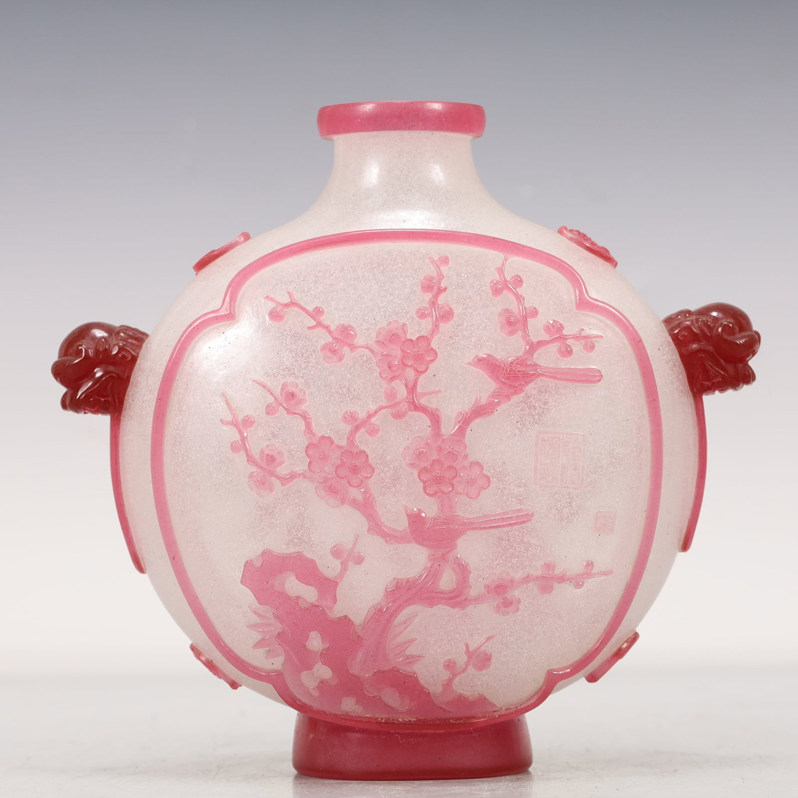 A Pink Overlay White Glass 'Flower& Bird' Lion-Handled Vase: A Pink Overlay White Glass 'Flower& Bird' Lion-Handled Vase. Painted with plum blossoms. Chinese Qing Dynasty. Qianlong Four-Character Mark. Size:7.1inx2.8inx7.1in 清代