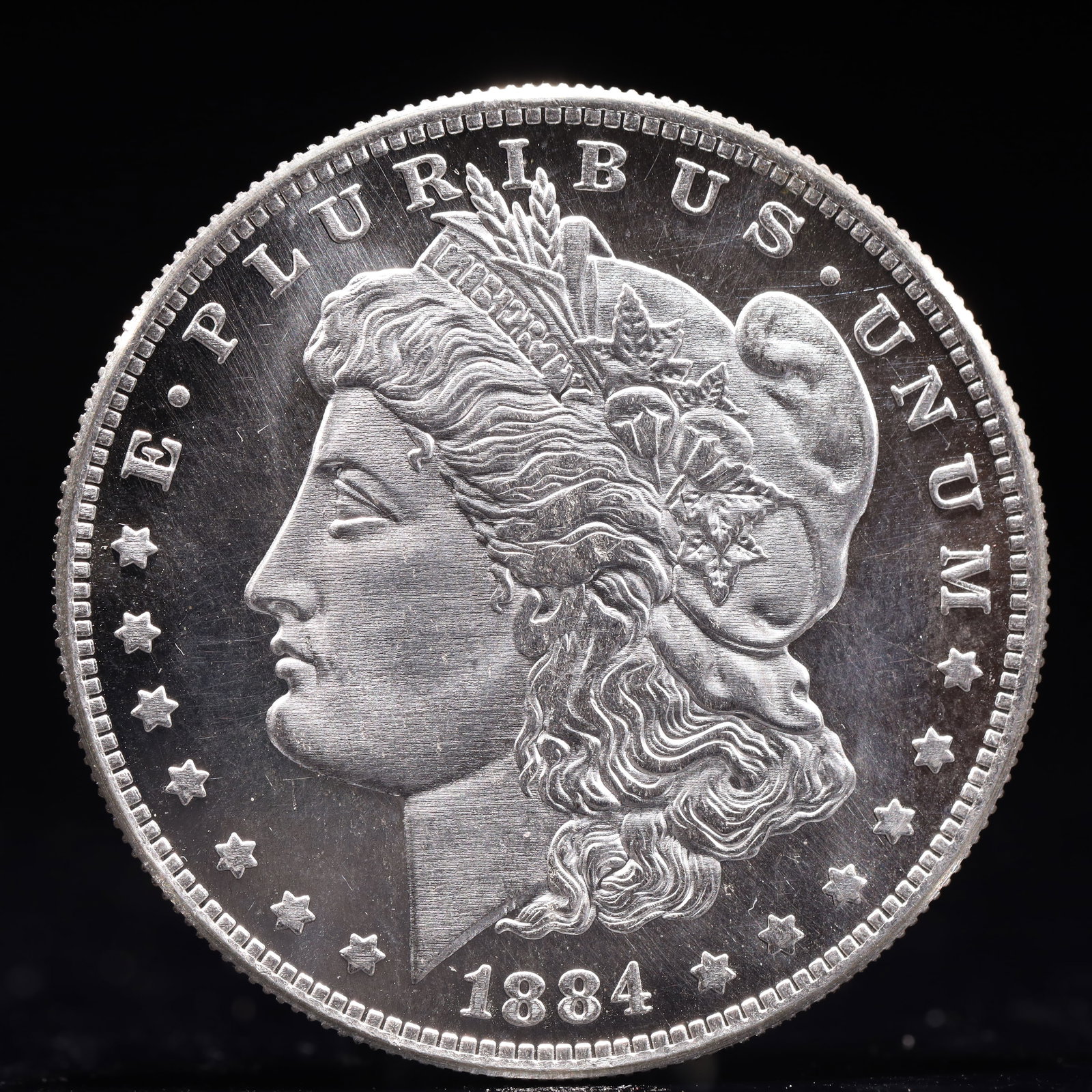 USA Morgan Dollar 1884 Coin: Estimated Value:2000-4000 Obv: profile bust with date below and E PLURIBUS UNUM legend and stars around. Rev: eagle with In God we trust above within wreath with UNITED STATES OF AMERICA ONE DOLLAR le
