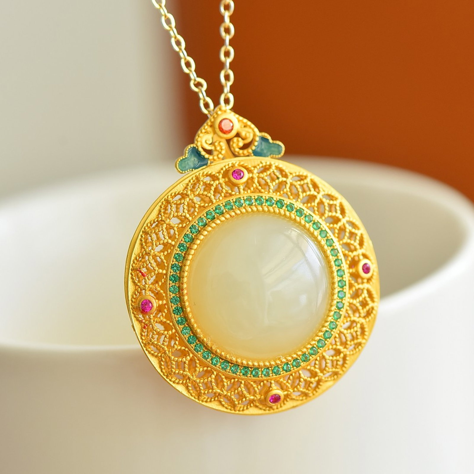 An Exquisite Sterling Silver-Gold Plated Inlaid White Jade Pendant: Estimated Value:400-800 An Exquisite Sterling Silver-Gold Plated Inlaid White Jade Pendant,Size:18mmx18mm 纯银镀金镶白玉吊坠