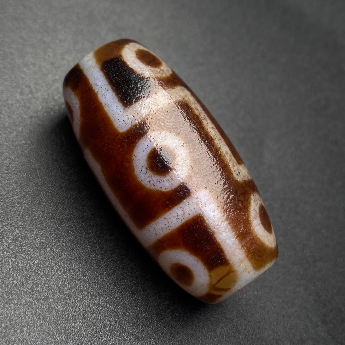 An Exquisite Nine Eyes Dzi Bead Pendant: Estimated Value:400-800 An Exquisite Nine Eyes Dzi Bead Pendant,Size:39mmx19mm,Weight:22.4g 九眼天珠挂件