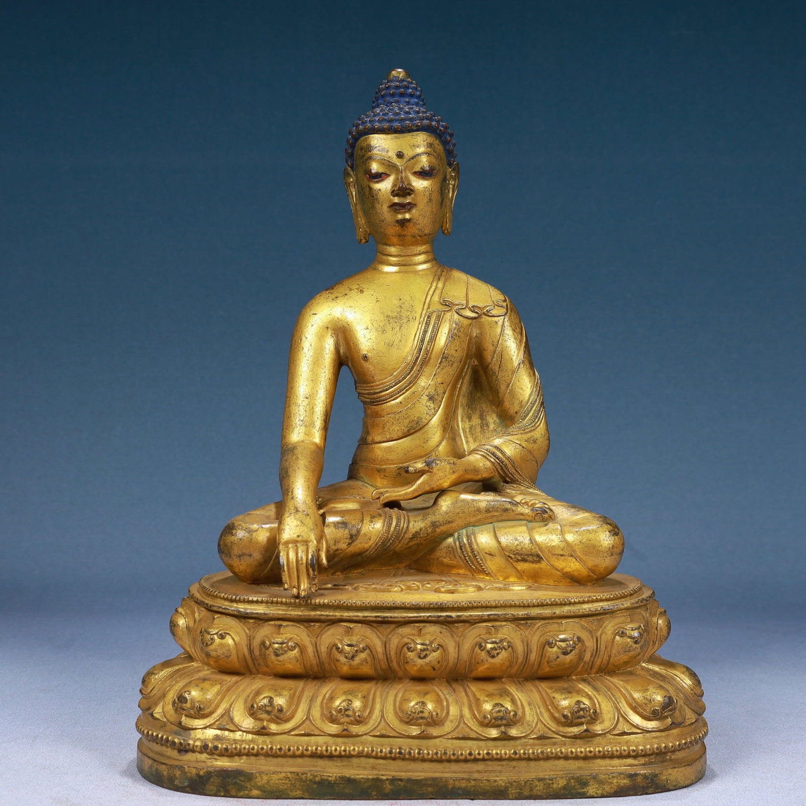 A Solemn Gilt Bronze Statue of Sakyamuni: Estimated Value:18000-36000 A Solemn Gilt Bronze Statue of Sakyamuni,Qing Dynasty, China,Size:9.1inx5.5inx11.8in,Weight:5200g