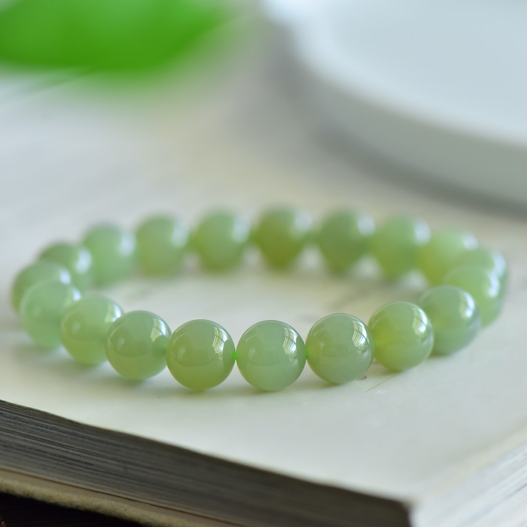 An Exquisite Greenish Jade Bracelets: Estimated Value:400-800 An Exquisite Greenish Jade Bracelets,Size:10mm 青白玉手串