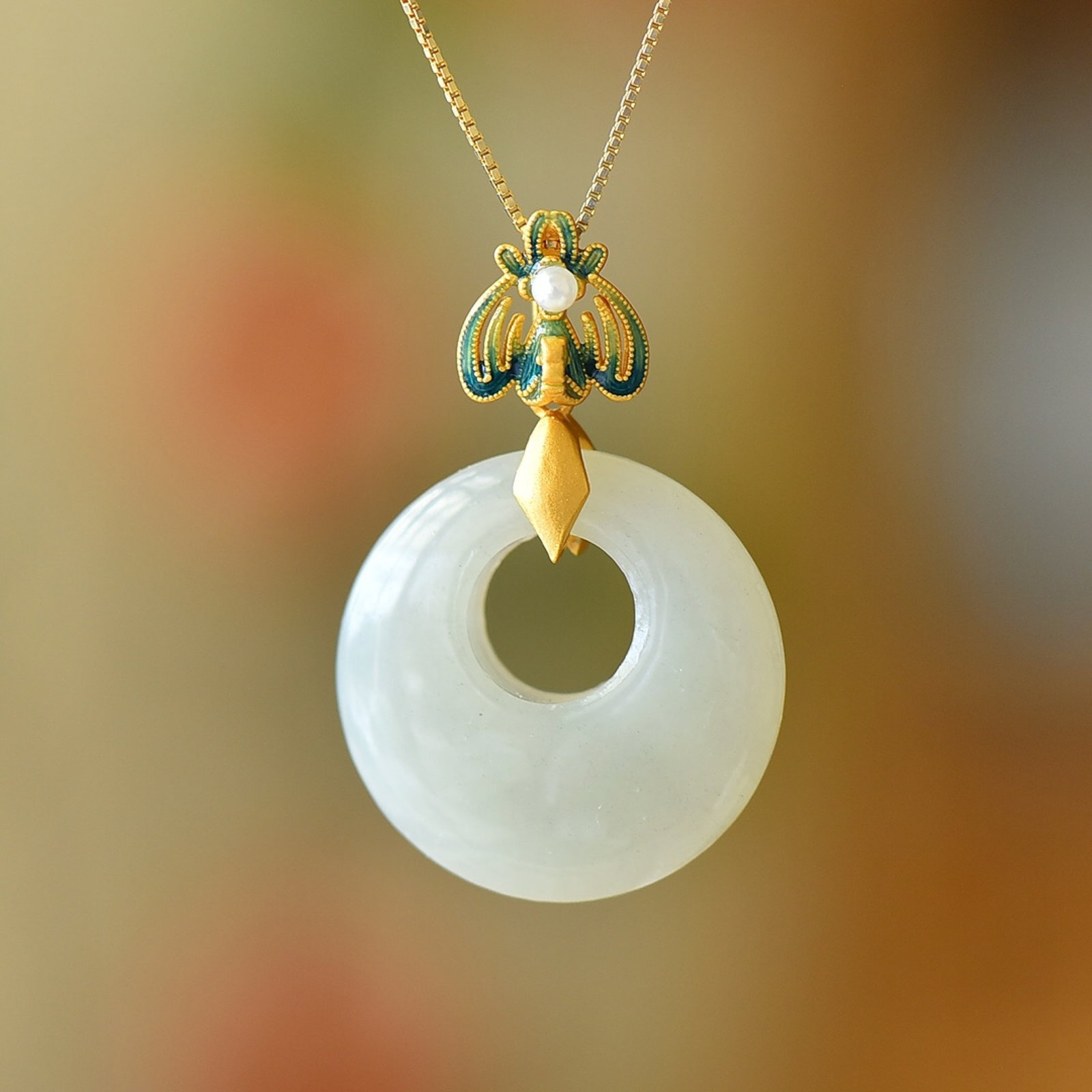 An Exquisite Sterling Silver-Gold Plated Inlaid White Jade Pendant: Estimated Value:300-600 An Exquisite Sterling Silver-Gold Plated Inlaid White Jade Pendant 纯银镀金镶白玉吊坠