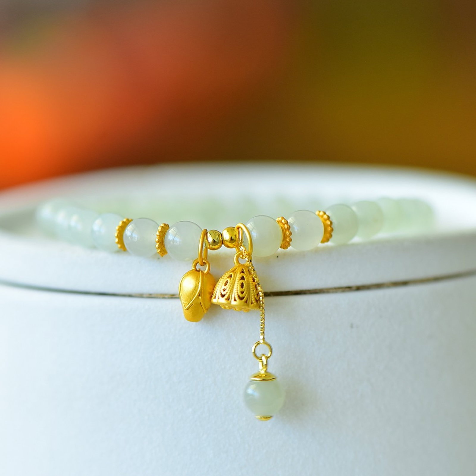 An Exquisite Sterling Silver-Gold Plated Inlaid White Jade Bracelets: Estimated Value:400-800 An Exquisite Sterling Silver-Gold Plated Inlaid White Jade Bracelets,Size:6mm 纯银镀金镶白玉手串