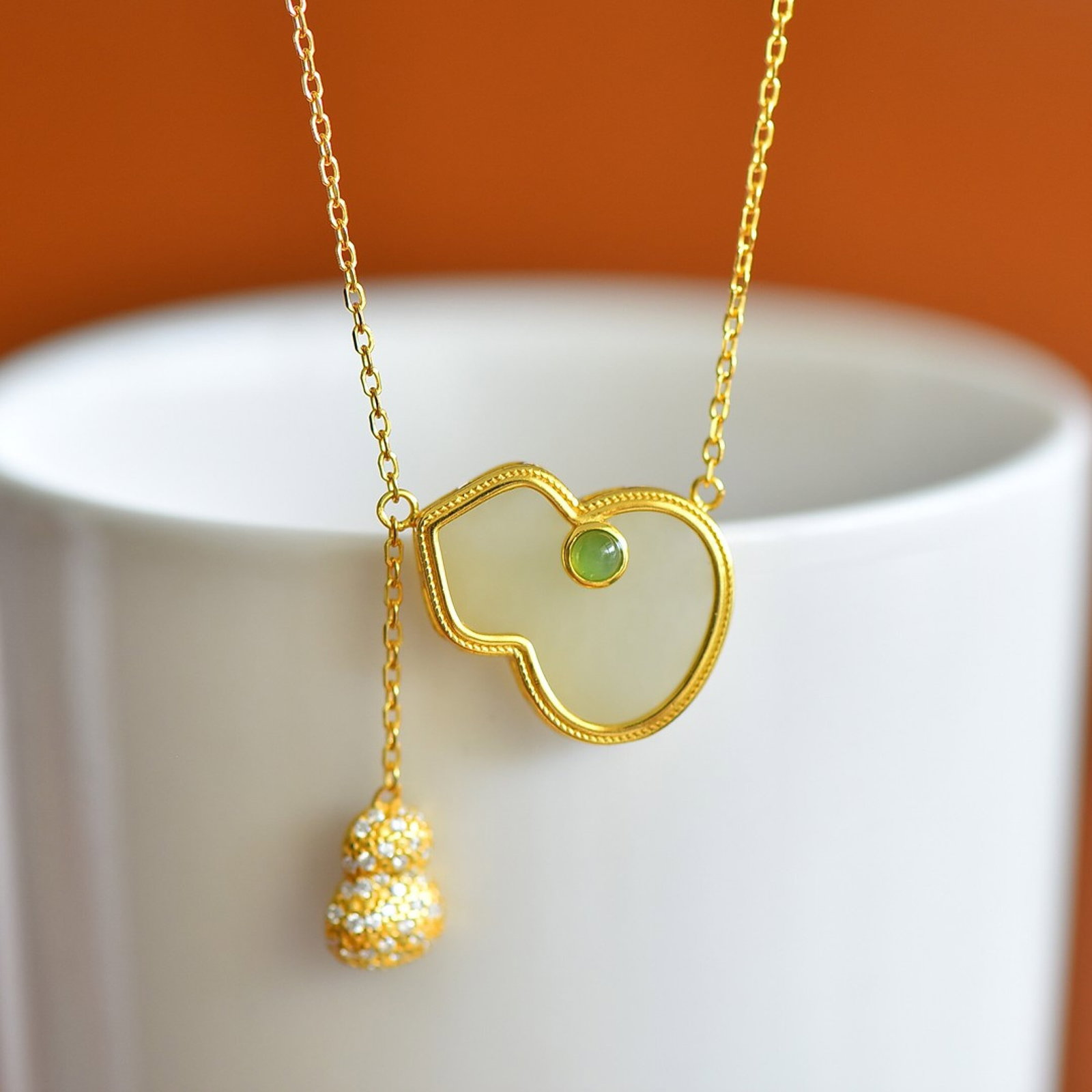 An Exquisite Sterling Silver-Gold Plated Inlaid White Jade Gourd Pendant,Inlaid Diamonds: Estimated Value:300-600 An Exquisite Sterling Silver-Gold Plated Inlaid White Jade Gourd Pendant,Inlaid Diamonds,Size:16mmx20mm