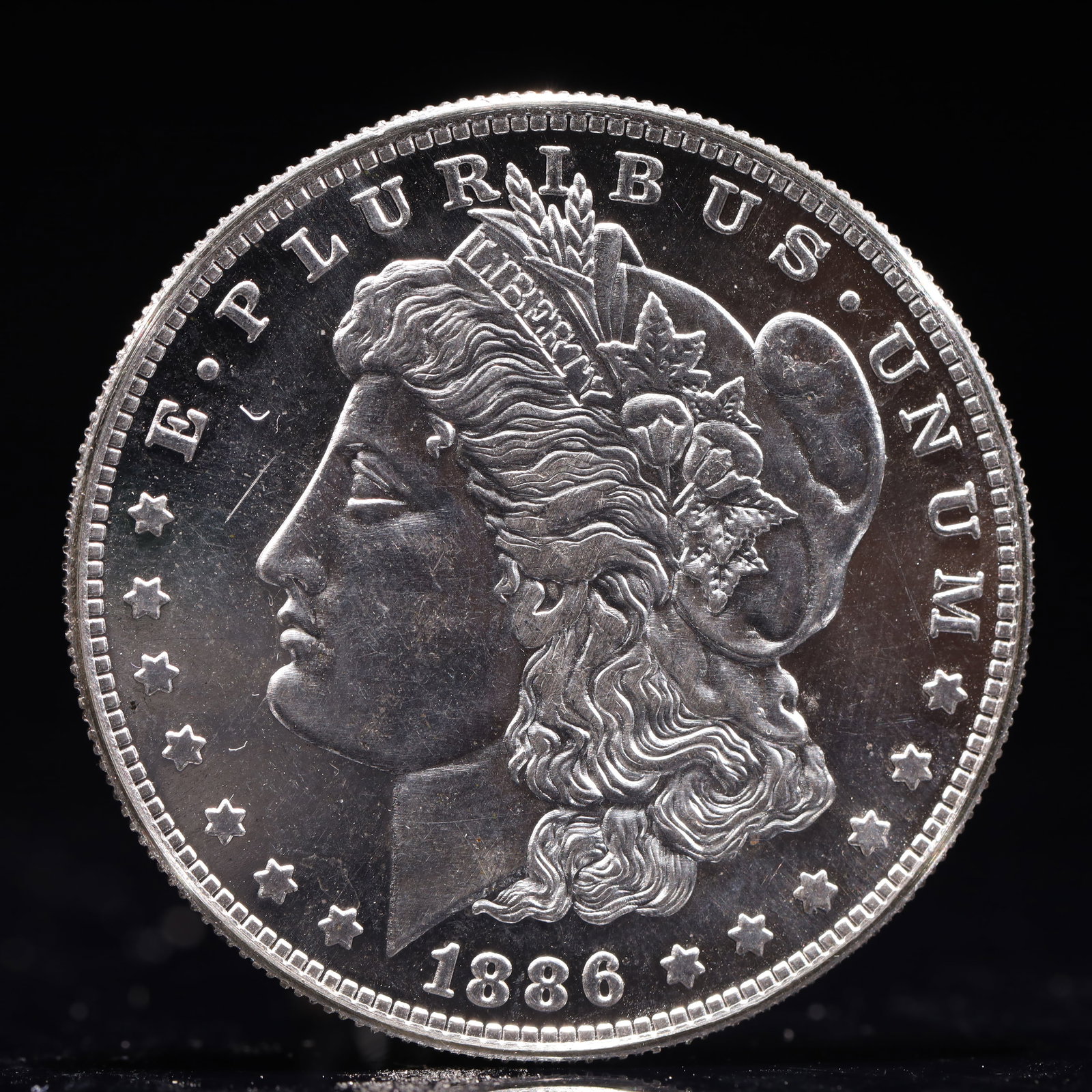 USA Morgan Dollar 1886 Coin: Estimated Value:2000-4000 Obv: profile bust with date below and E PLURIBUS UNUM legend and stars around. Rev: eagle with In God we trust above within wreath with UNITED STATES OF AMERICA ONE DOLLAR le