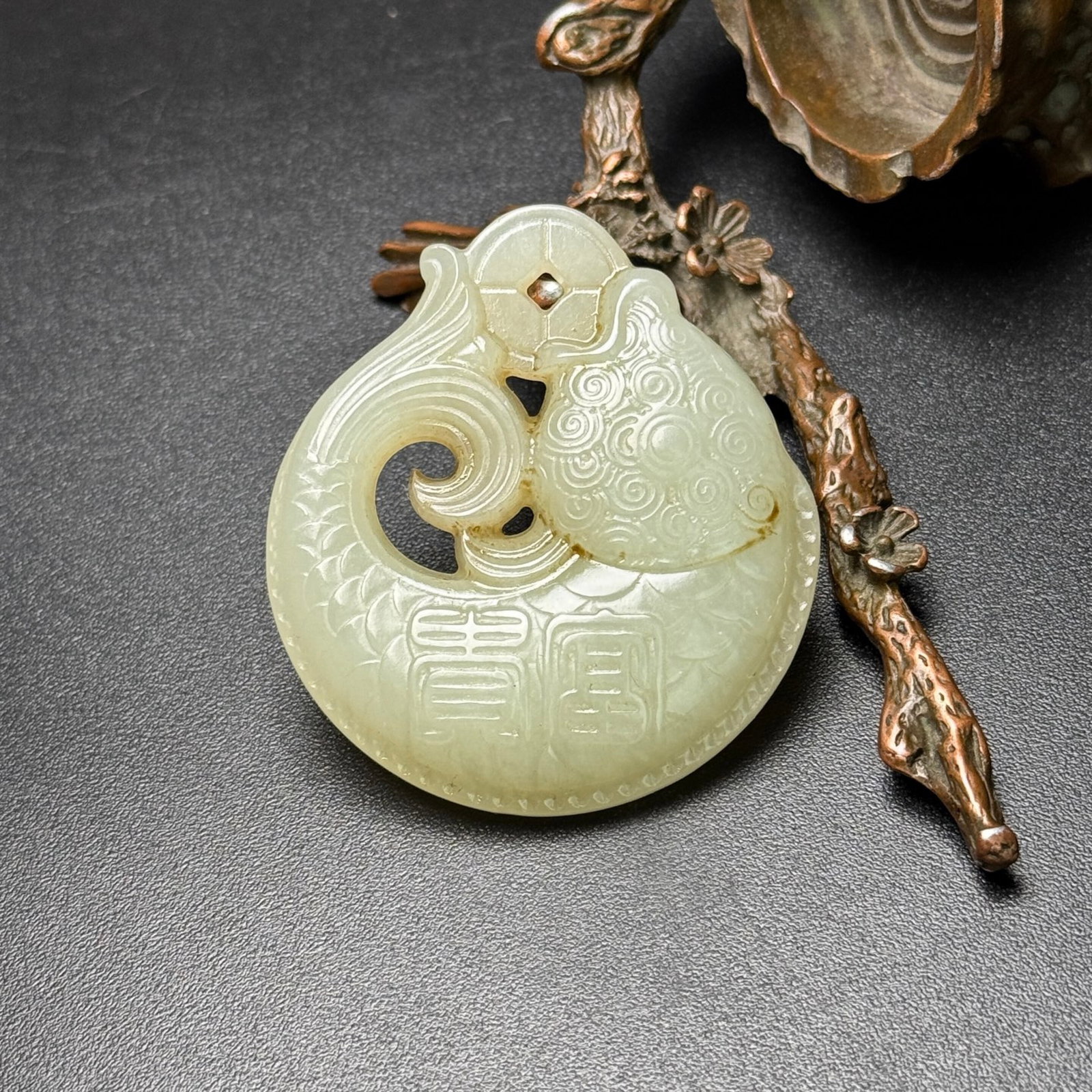 An Exquisite White Jade Fish-Shaped Pendant: Estimated Value:440-880 An Exquisite White Jade Fish-Shaped Pendant,Qing Dynasty,China,Size:51mmx46mmx11mm,Weight:33g 白玉鱼形挂件,中国清代