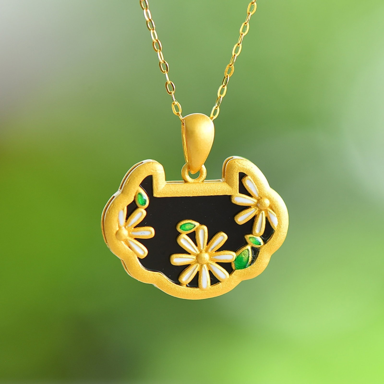 An Exquisite Sterling Silver-Gold Plated Inlaid Black Jade Pendant: Estimated Value:300-600 An Exquisite Sterling Silver-Gold Plated Inlaid Black Jade Pendant 纯银镀金镶黑玉吊坠