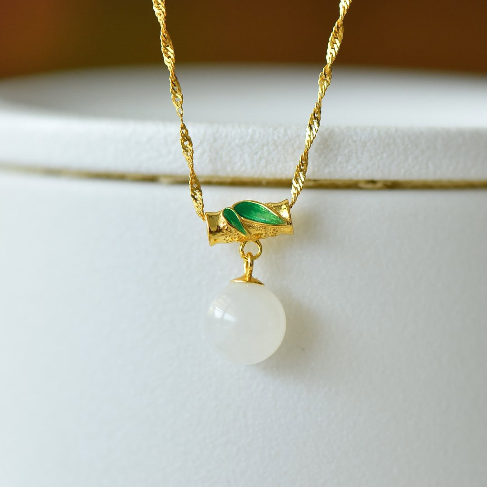 An Exquisite Sterling Silver-Gold Plated Inlaid White Jade Pendant: Estimated Value:200-400 An Exquisite Sterling Silver-Gold Plated Inlaid White Jade Pendant,Size:10mm 纯银镀金镶白玉吊坠