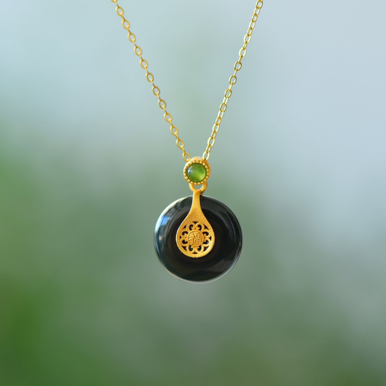 An Exquisite Sterling Silver-Gold Plated Inlaid Black Jade Pendant: Estimated Value:200-400 An Exquisite Sterling Silver-Gold Plated Inlaid Black Jade Pendant 纯银镀金镶黑玉吊坠