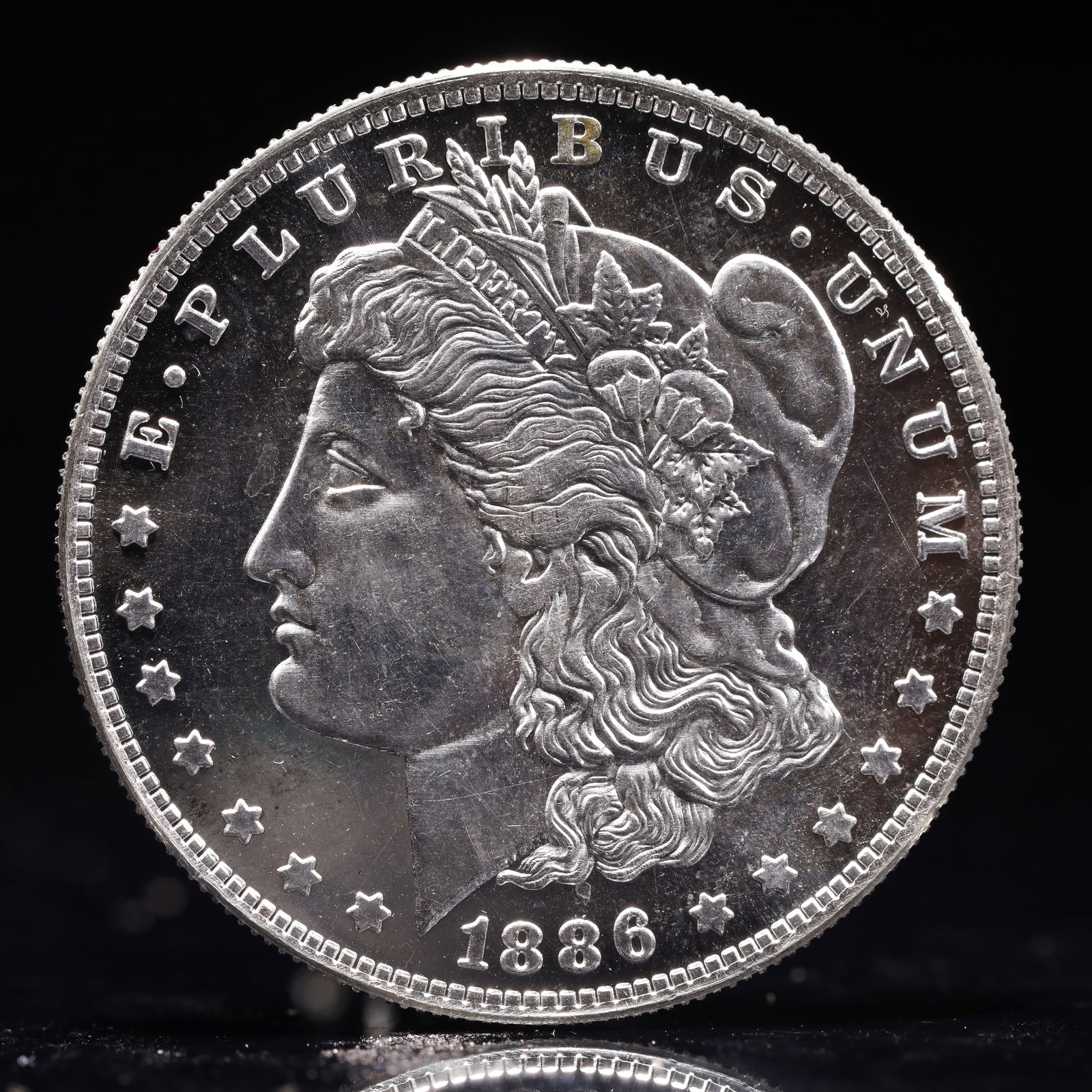USA Morgan Dollar 1886 Coin: Estimated Value:2000-4000 Obv: profile bust with date below and E PLURIBUS UNUM legend and stars around. Rev: eagle with In God we trust above within wreath with UNITED STATES OF AMERICA ONE DOLLAR