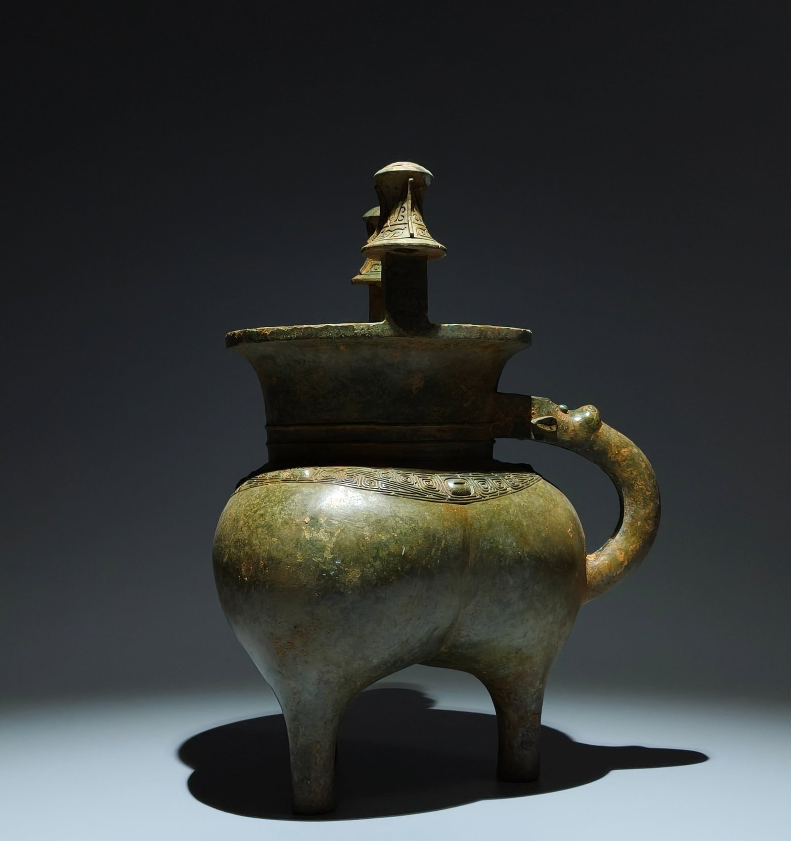 An Archaic Bronze Cloud and Thunder Pattern Double-Ears Tripod Libation Cup (1 of 9)