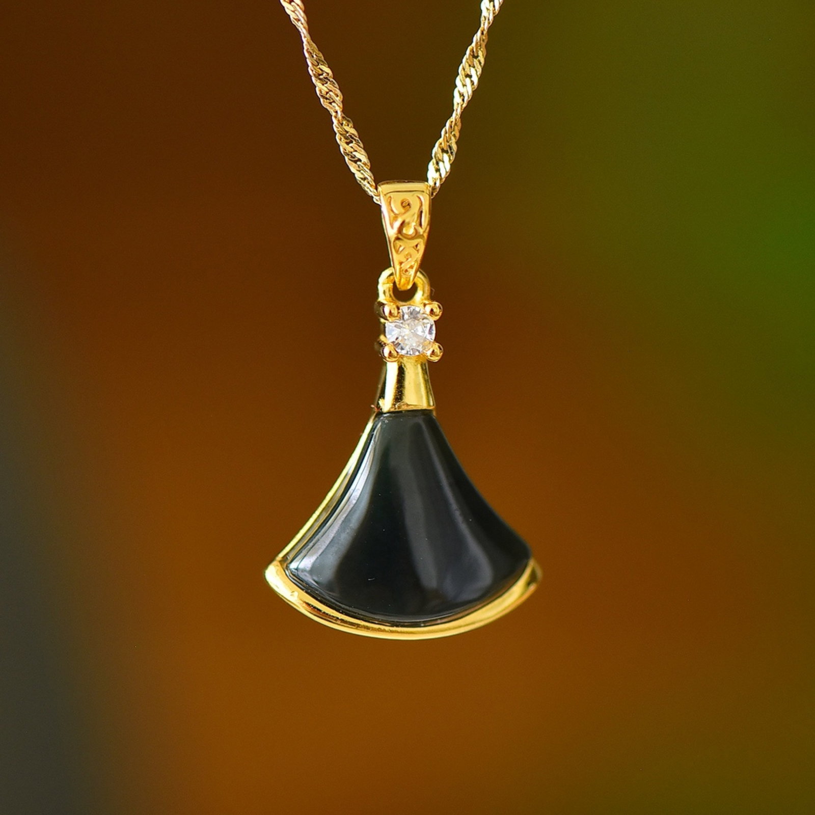 An Exquisite Sterling Silver-Gold Plated Inlaid Black Jade Pendant: Estimated Value:300-600 An Exquisite Sterling Silver-Gold Plated Inlaid Black Jade Pendant,Size:12mmx15mm 纯银镀金镶黑玉吊坠