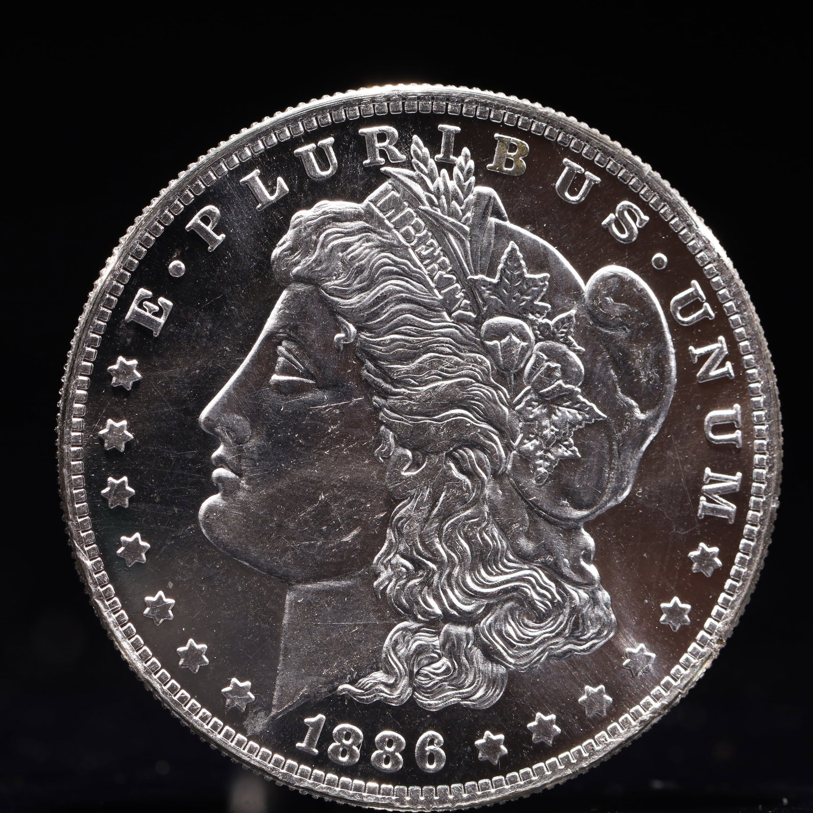 USA Morgan Dollar 1886 Coin: Estimated Value:2000-4000 Obv: profile bust with date below and E PLURIBUS UNUM legend and stars around. Rev: eagle with In God we trust above within wreath with UNITED STATES OF AMERICA ONE DOLLAR le