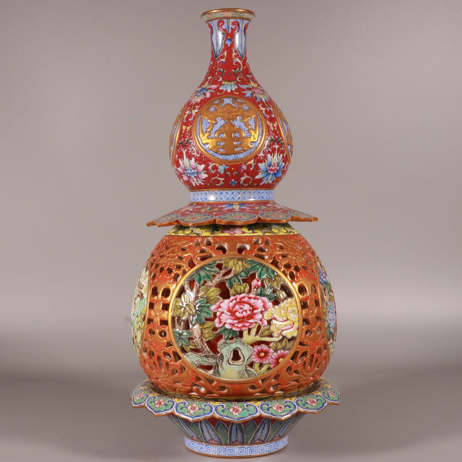 A Rare Famille-Rose Ruby Red-Ground Painted Gold Hollow Flower Pattern Gourd Vase: Estimated Value:4400-8800 A Rare Famille-Rose Ruby Red-Ground Painted Gold Hollow Flower Pattern Gourd Vase,Qing Dynasty, China,Qianlong Six-character Mark,Size:14.8inx1.9inx7.1inx3.3in
