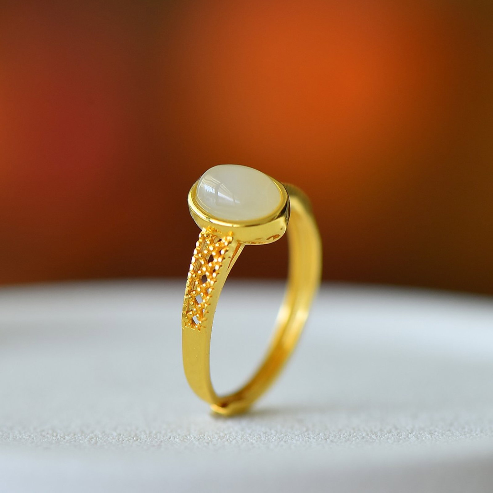An Exquisite Sterling Silver-Gold Plated Inlaid White Jade Ring: Estimated Value:200-400 An Exquisite Sterling Silver-Gold Plated Inlaid White Jade Ring,Size:6mmx8mm 纯银镀金镶白玉戒指