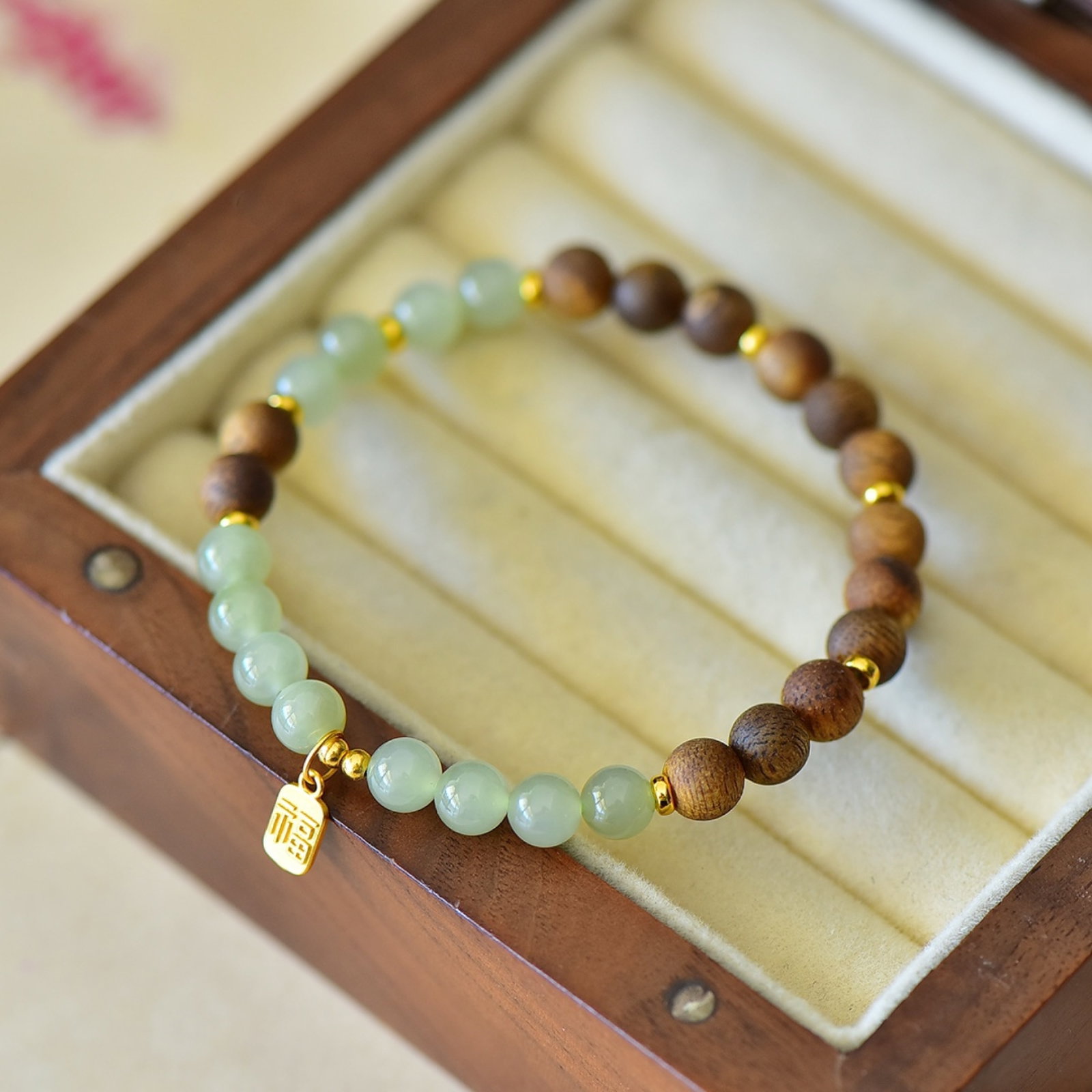 An Exquisite Greenish Jade Eaglewood Bracelets: Estimated Value:200-400 An Exquisite Greenish Jade Eaglewood Bracelets,Size:6mmx6mm 青白玉沉香木手串