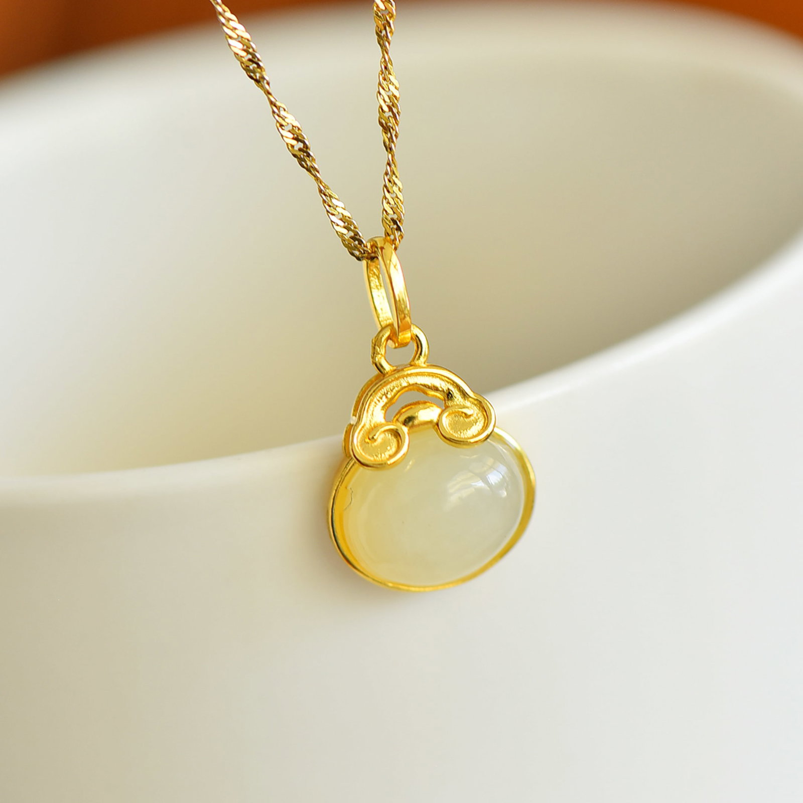 An Exquisite Sterling Silver-Gold Plated Inlaid White Jade Pendant: Estimated Value:200-400 An Exquisite Sterling Silver-Gold Plated Inlaid White Jade Pendant,Size:8mmx10mm 纯银镀金镶白玉吊坠