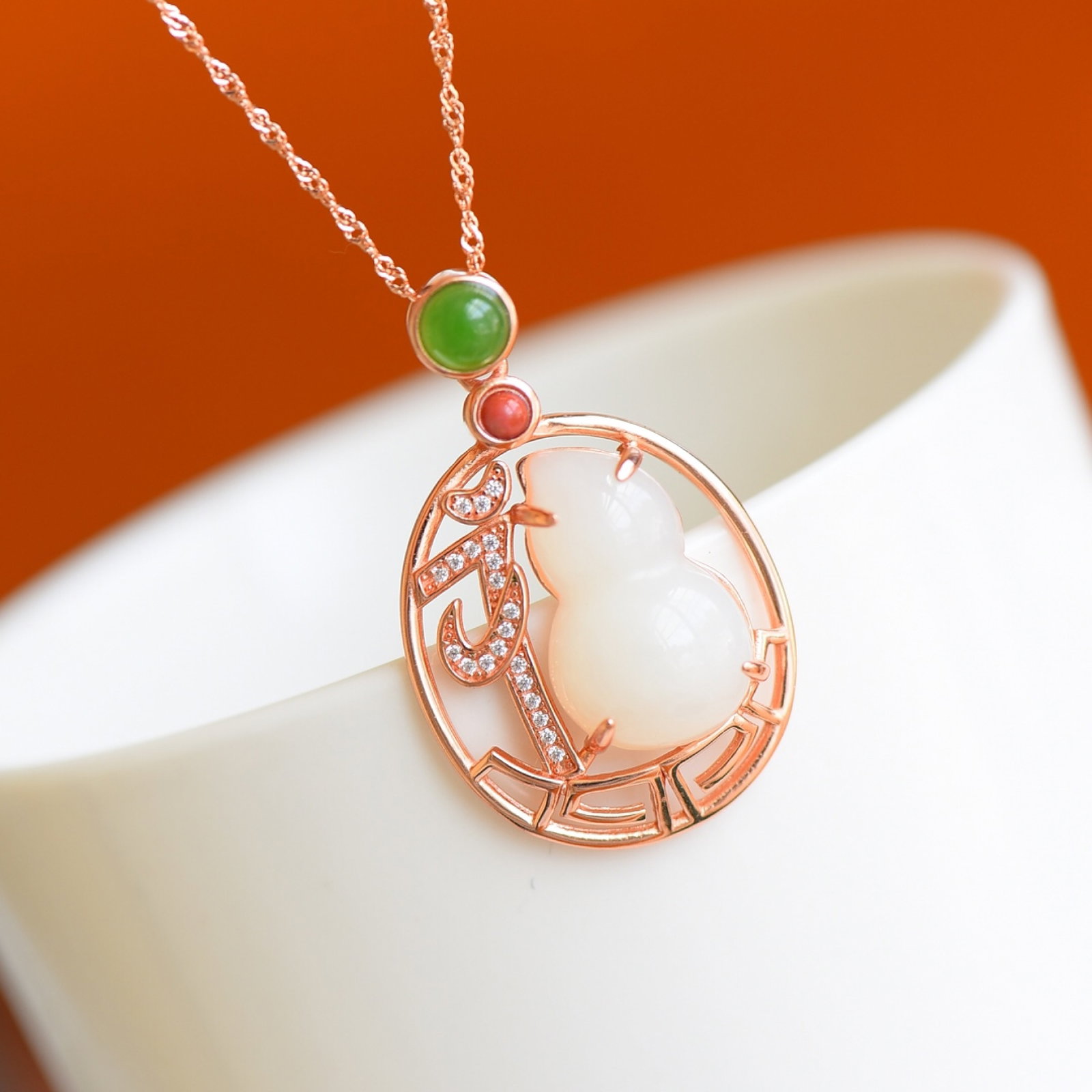 An Exquisite Sterling Silver-Gold Plated Inlaid White Jade Pendant,Inlaid Jasper and Gems: Estimated Value:300-600 An Exquisite Sterling Silver-Gold Plated Inlaid White Jade Pendant,Inlaid Jasper and Gems,Size:12mmx20mm