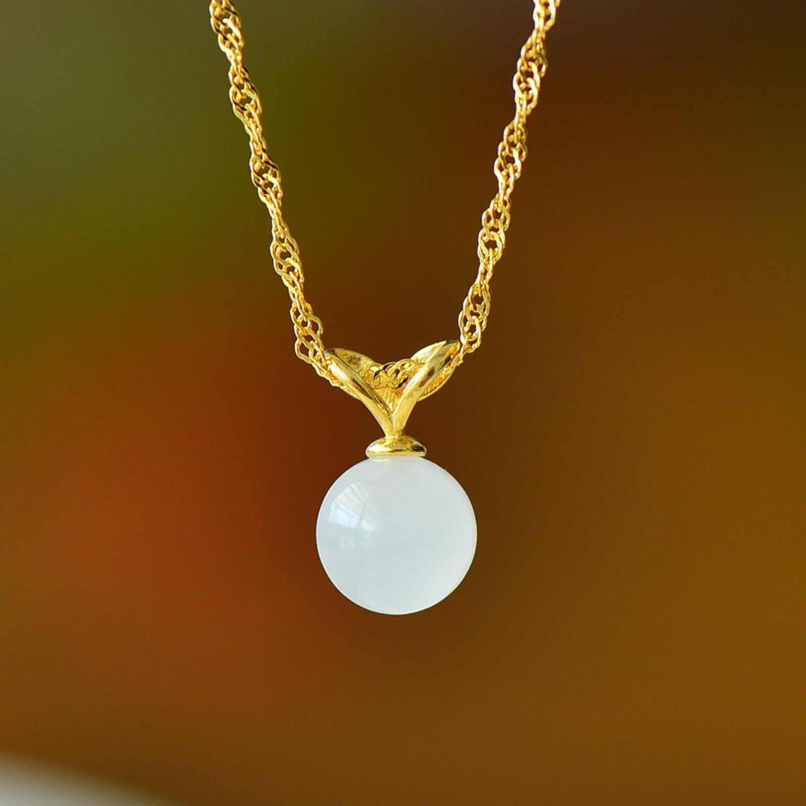 An Exquisite Sterling Silver-Gold Plated Inlaid White Jade Pendant: Estimated Value:200-400 An Exquisite Sterling Silver-Gold Plated Inlaid White Jade Pendant,Size:8mm 纯银镀金镶白玉吊坠