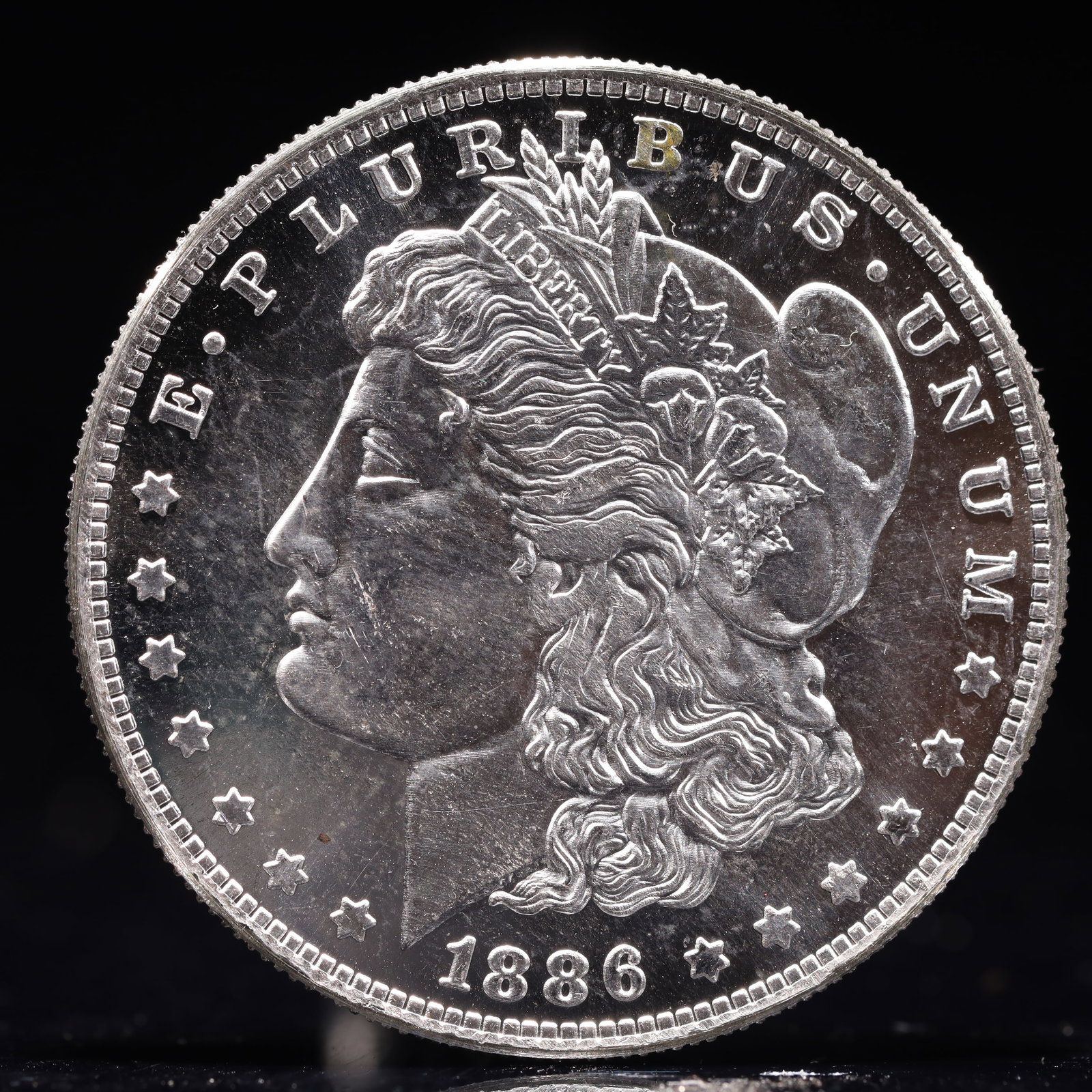 USA Morgan Dollar 1886 Coin: Estimated Value:2000-4000 Obv: profile bust with date below and E PLURIBUS UNUM legend and stars around. Rev: eagle with In God we trust above within wreath with UNITED STATES OF AMERICA ONE DOLLAR le