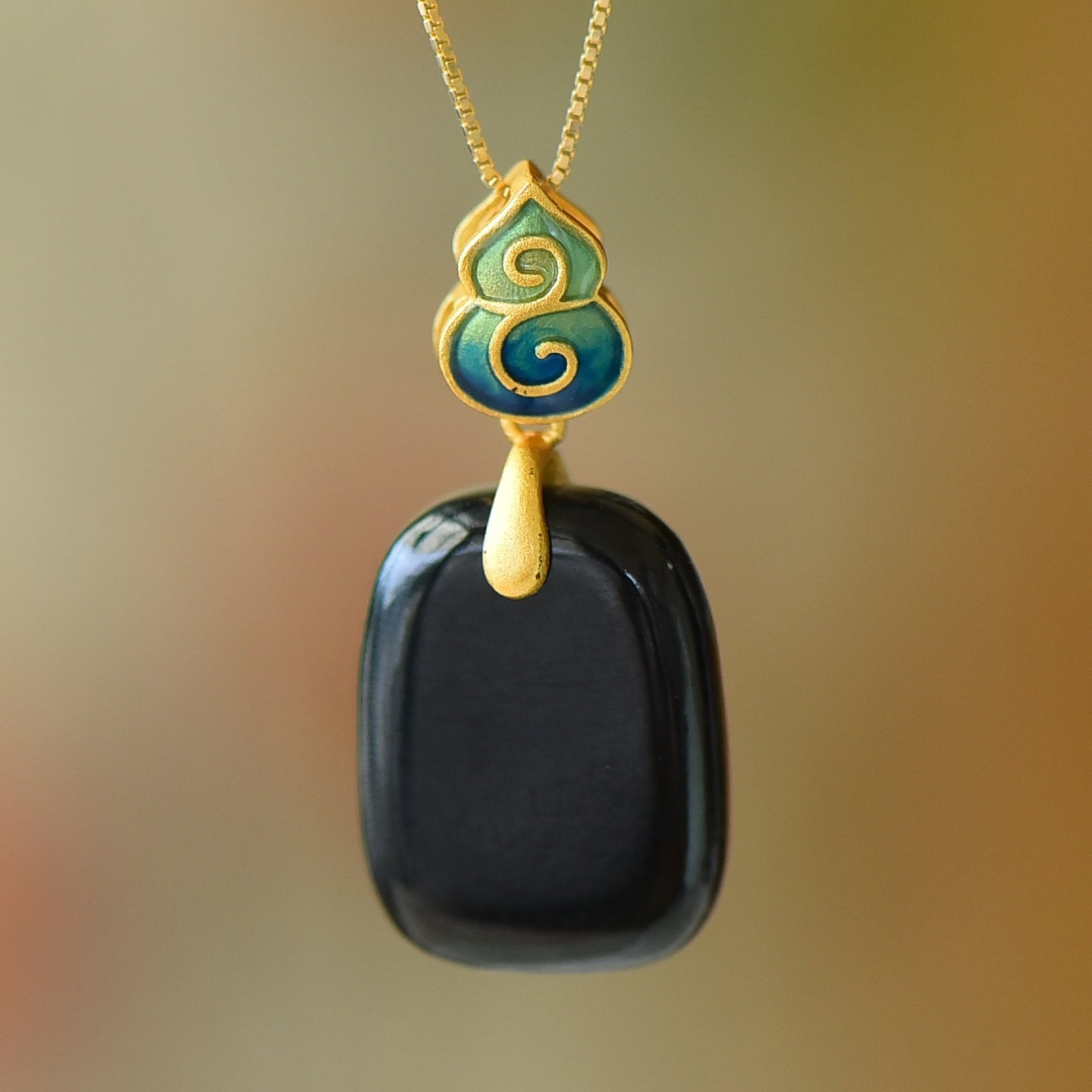 An Exquisite Sterling Silver-Gold Plated Inlaid Black Jade Pendant: Estimated Value:200-400 An Exquisite Sterling Silver-Gold Plated Inlaid Black Jade Pendant,Size:15mmx20mm 纯银镀金镶黑玉吊坠