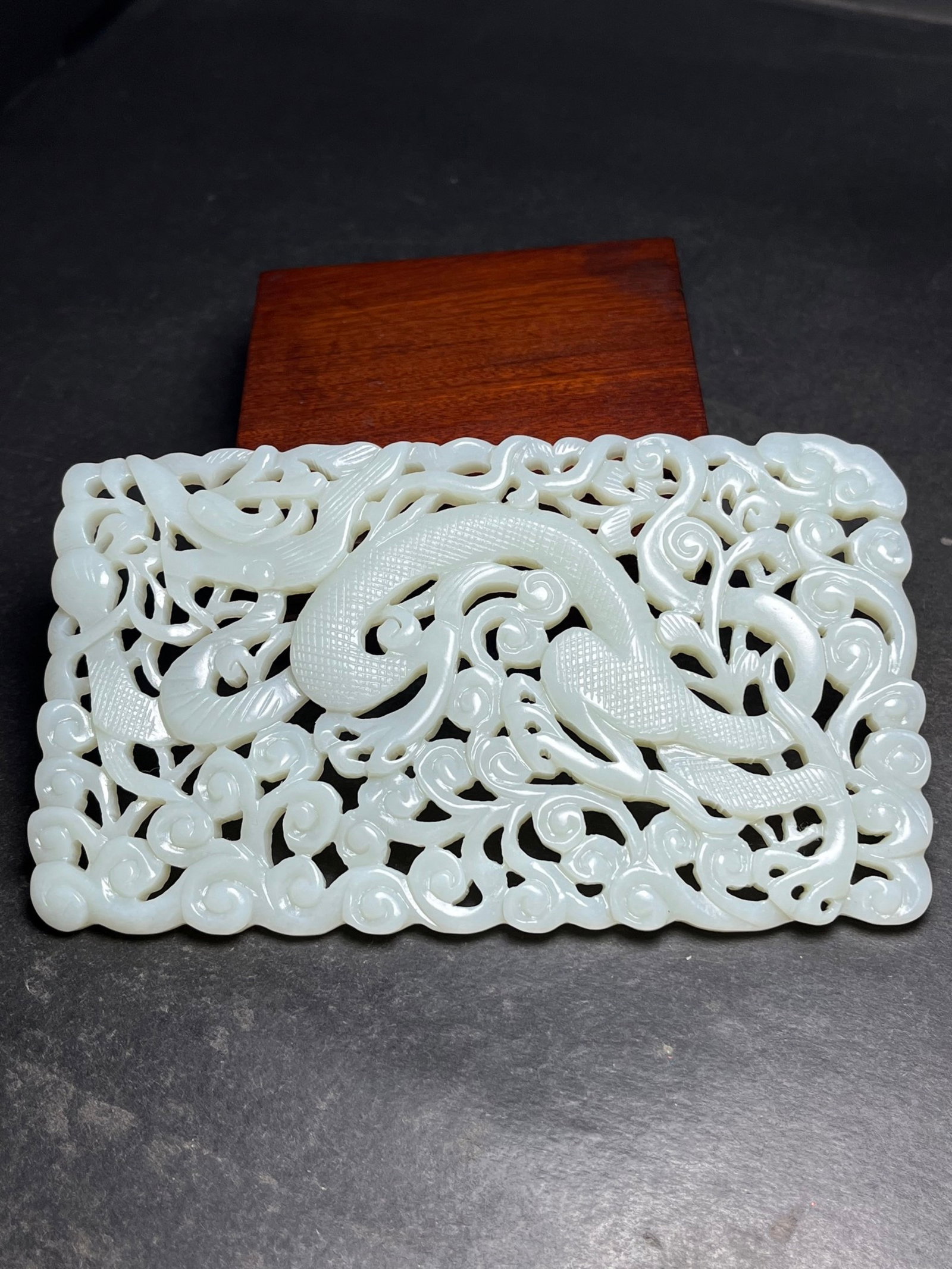 An Exquisite White Jade Hollow Dragon Pattern Pendant: Estimated Value:920-1900 An Exquisite White Jade Hollow Dragon Pattern Pendant,Qing Dynasty,China,Size:131mmx7mmx75mm,Weight:137g