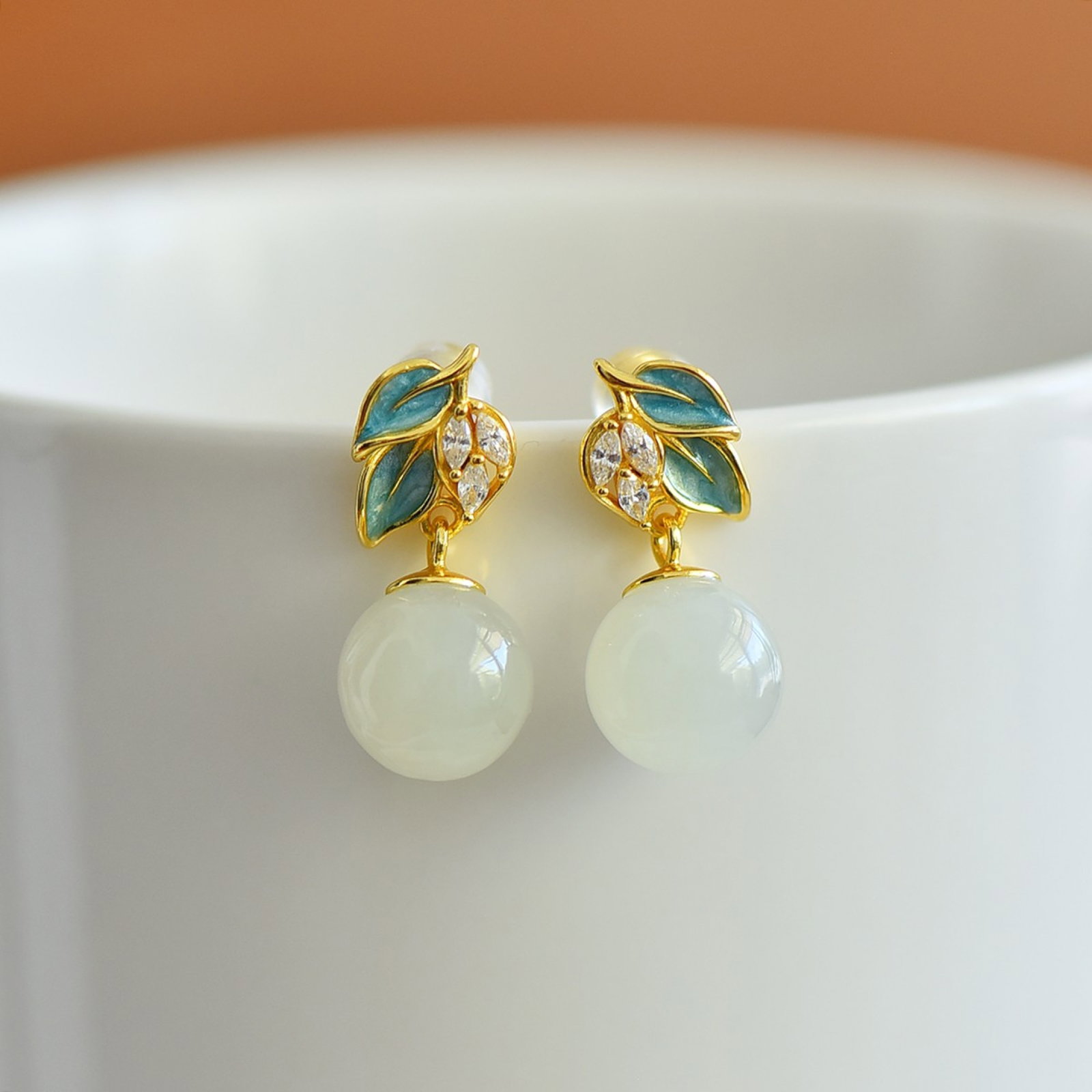 A Pair of Exquisite Sterling Silver-Gold Plated Inlaid White Jade Enamel Earrings: Estimated Value:200-400 A Pair of Exquisite Sterling Silver-Gold Plated Inlaid White Jade Enamel Earrings,Size: 10mmx10mm