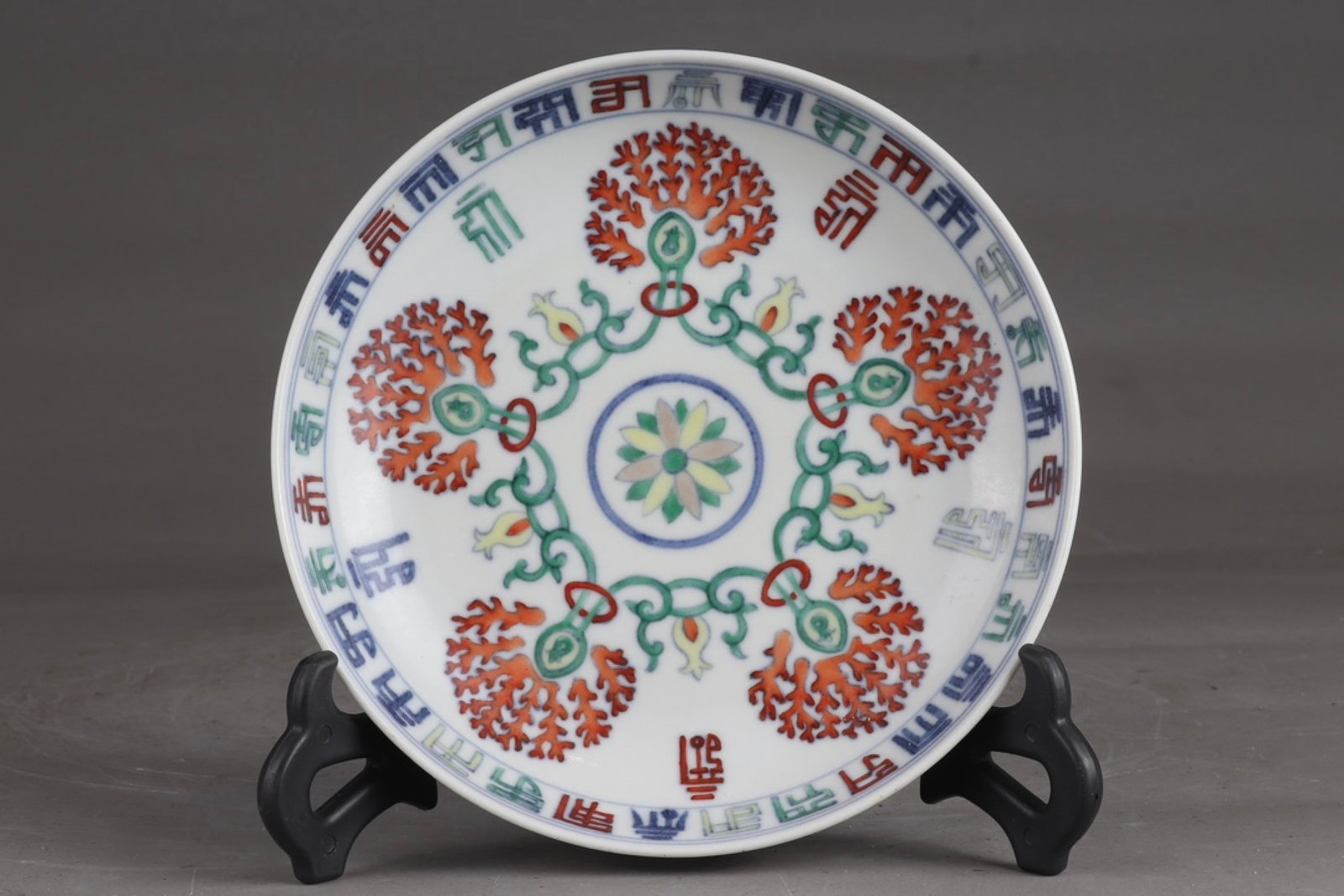 An Exquisite Doucai Flower Pattern Plate,With Sanskrit: An Exquisite Doucai Flower Pattern Plate,With Sanskrit,Qing Dynasty,China,Qianlong Six-character Mark,Size:1.3inx6.3in