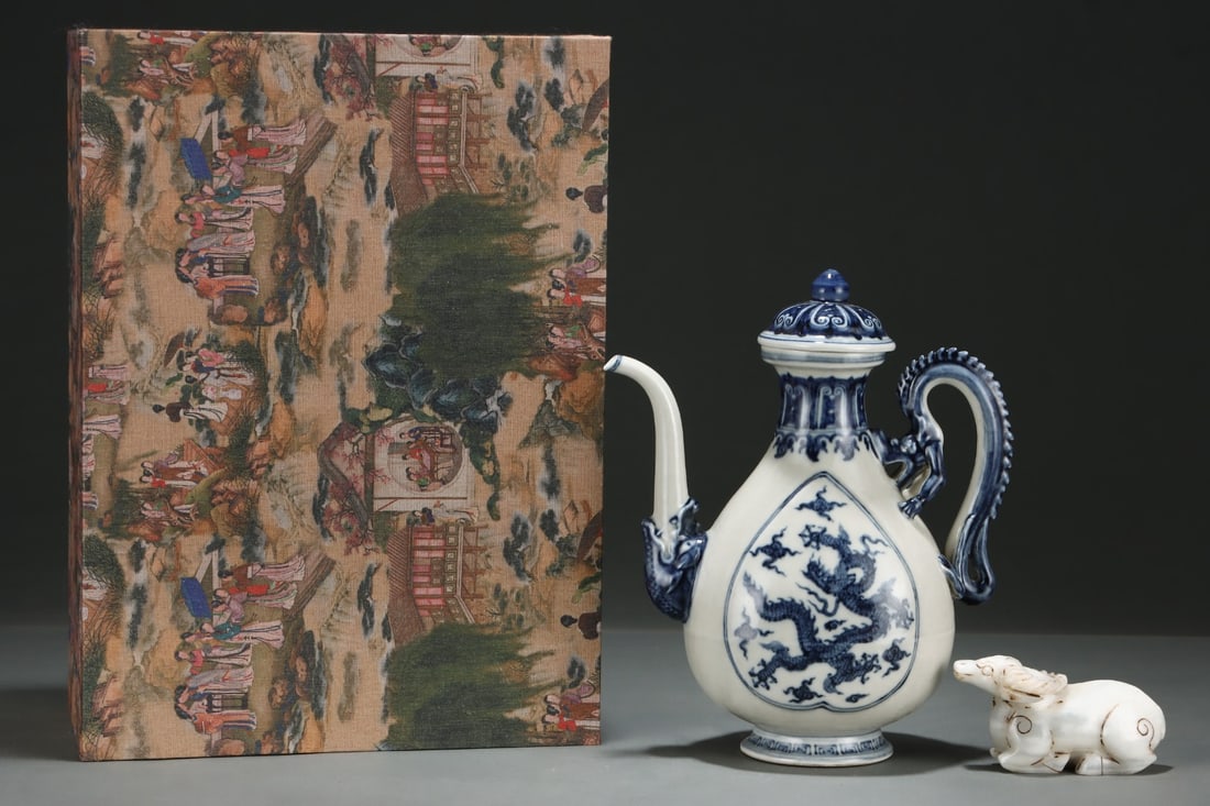 An Exquisite Blue and White Auspicious Cloud and Dragon Pattern Ewer,With White Jade Sheep Ornament: An Exquisite Blue and White Auspicious Cloud and Dragon Pattern Ewer,With White Jade Sheep Ornament,Ming Dynasty,China,Size:10.8inx9.1in,(Jade)2.4inx4.7in 青花祥云龙ń