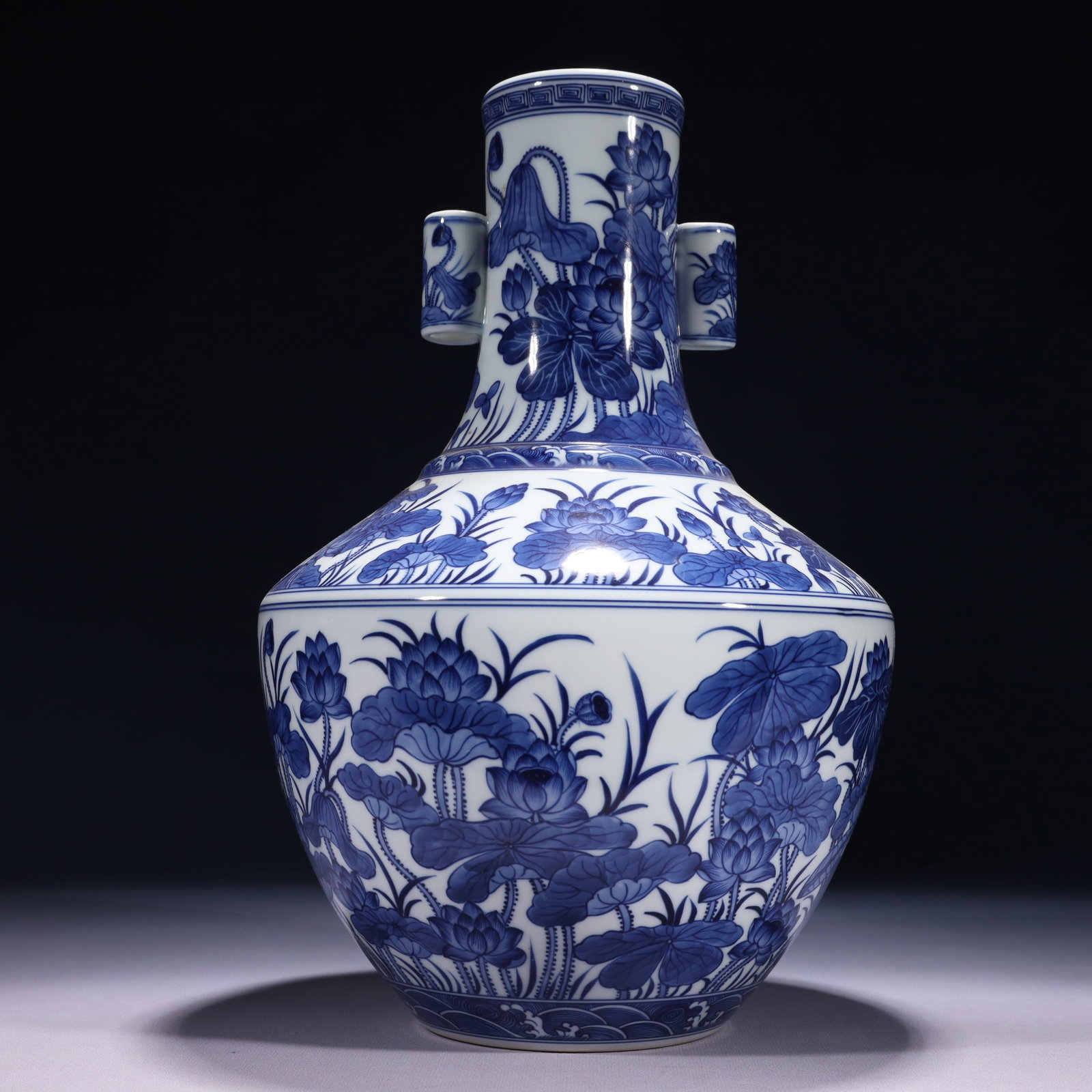 An Exquisite Blue and White Lotus Pattern Double-Ears Vase: An Exquisite Blue and White Lotus Pattern Double-Ears Vase,Qing Dynasty,China,Qianlong Six-character Mark,Size:8.3inx13in,Weight:2550g 青花荷花纹双耳瓶,