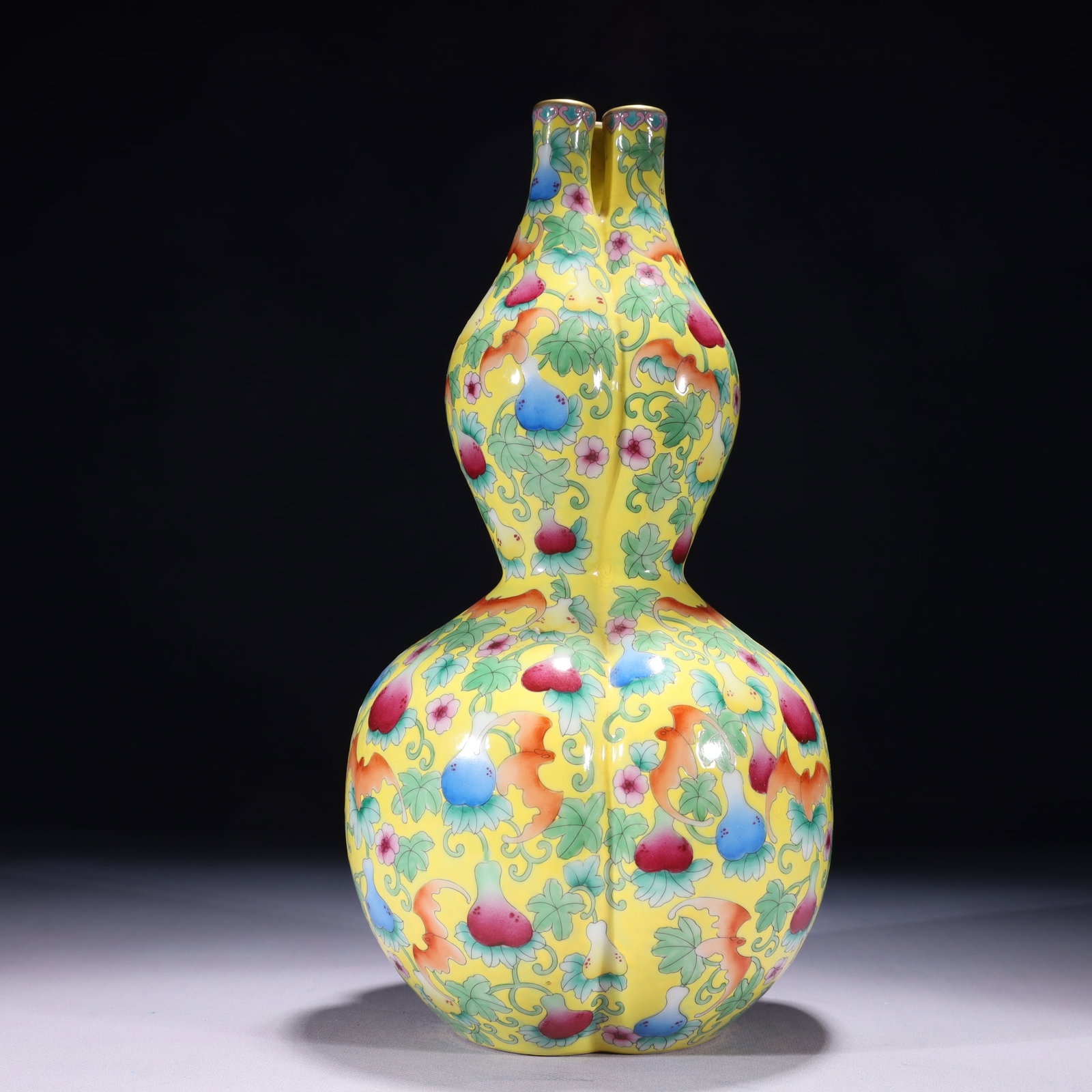 An Exquisite Yellow Ground Famille-Rose Painted Gold Bats Pattern Gourd-Shaped Vase: An Exquisite Yellow Ground Famille-Rose Painted Gold Bats Pattern Gourd-Shaped Vase,Qing Dynasty,China,Qianlong Four-character Mark,Size:6.7inx13.8in,Weight:2150g 黄地粉彩ÿ