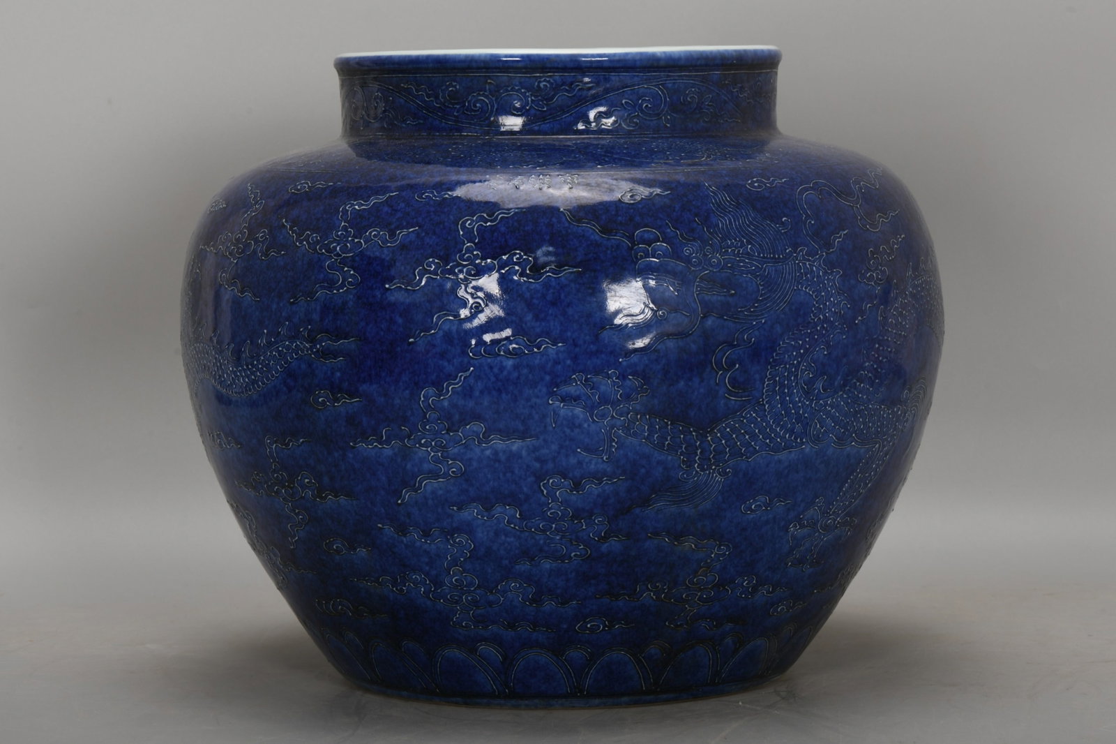 A Rare Blue Glazed Auspicious Cloud and Dragon Pattern Jar: A Rare Blue Glazed Auspicious Cloud and Dragon Pattern Jar,Ming Dynasty,China,Size:11.8inx14.2in 蓝釉祥云龙纹罐,中国明代