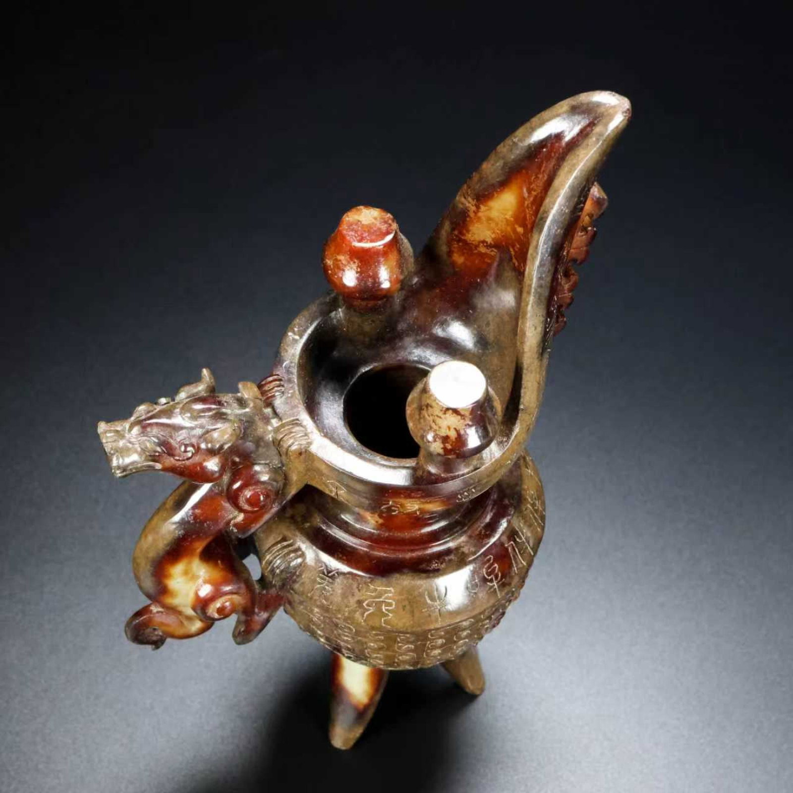 An Exquisite White Jade Dragon-head Tripod Goblet,With Inscription: An Exquisite White Jade Dragon-head Tripod Goblet,With Inscription,Qing Dynasty,China,Size:4.3inx3.1inx7.9in,Weight:622g 白玉龙首三足爵杯,带໤