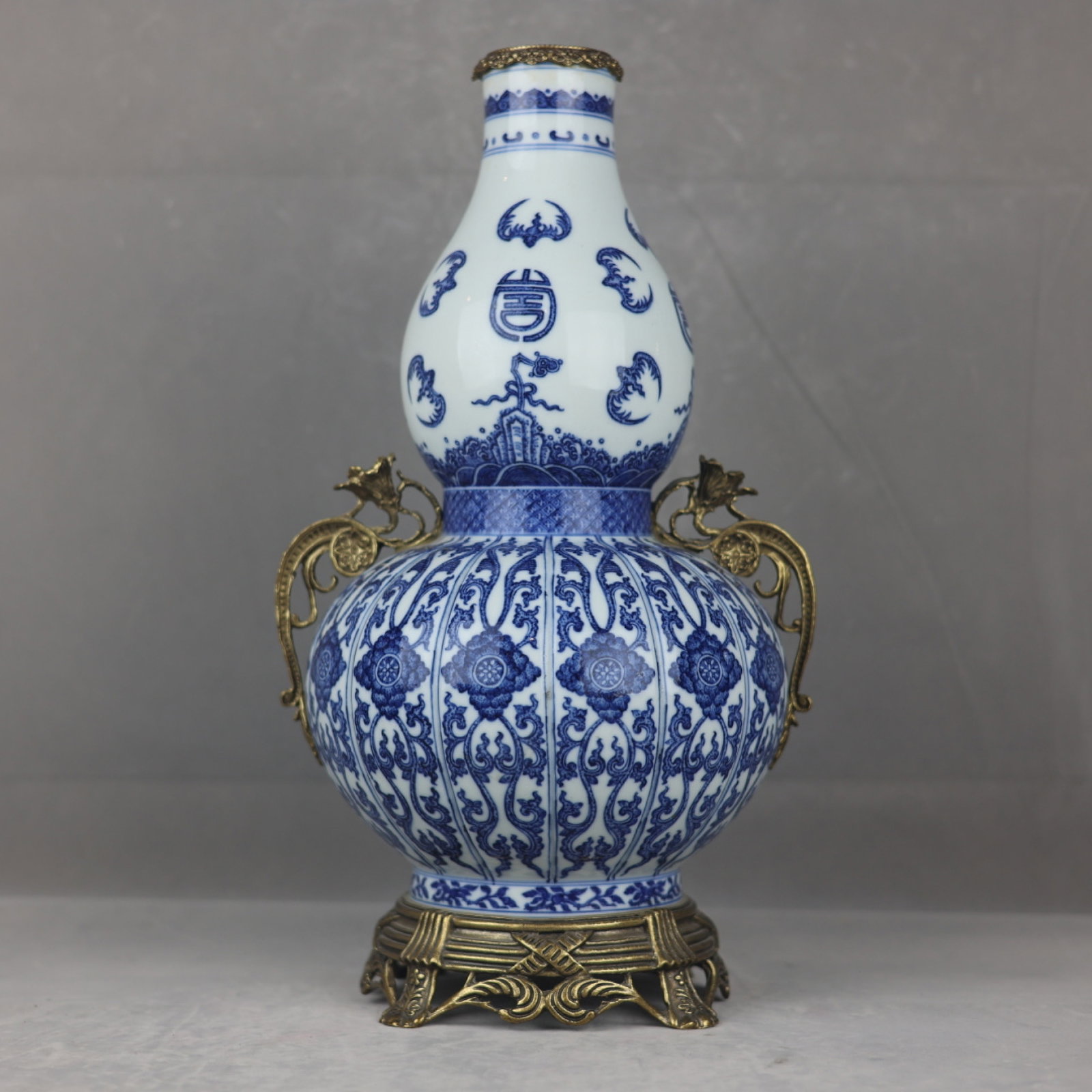 A Huge Blue and White Inlaid Gilt Bronze Lotus Pattern Double-Ears Gourd-Shaped Vase: A Huge Blue and White Inlaid Gilt Bronze Lotus Pattern Double-Ears Gourd-Shaped Vase,Qing Dynasty,China,Qianlong Six-character Mark,Size:18.5inx10.2in 青花镶铜鎏金&