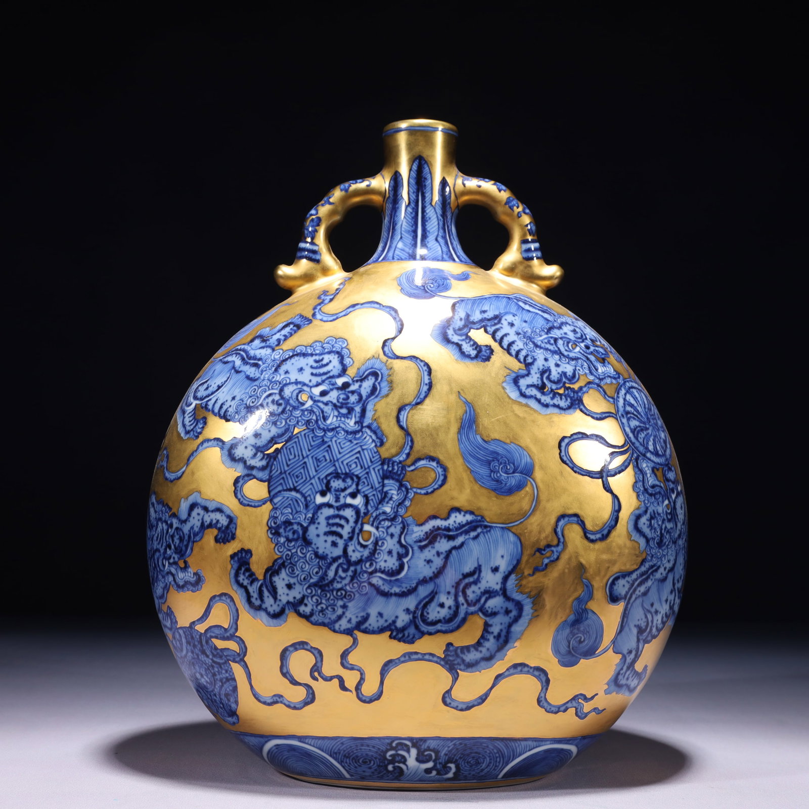 An Exquisite Gold Ground Blue and White Painted Gold Lion Pattern Double-Ears Vase: An Exquisite Gold Ground Blue and White Painted Gold Lion Pattern Double-Ears Vase,Qing Dynasty,China,Yongzheng Six-character Mark,Size:9.1inx5.1inx12.2in,Weight:3050g 金地青花