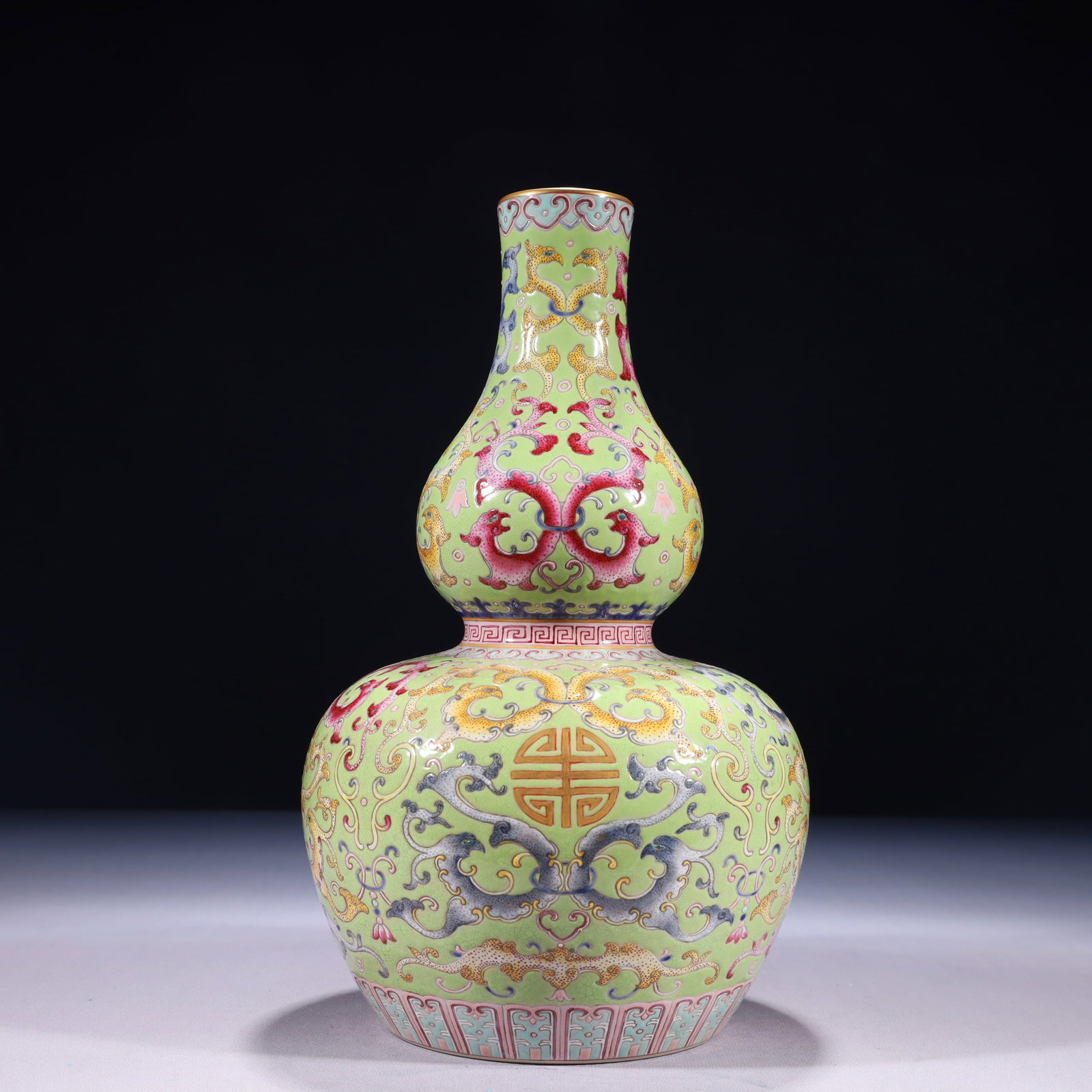 An Exquisite Green Ground Famille-Rose Painted Gold Lotus Pattern Gourd-Shaped Vase: An Exquisite Green Ground Famille-Rose Painted Gold Lotus Pattern Gourd-Shaped Vase,Qing Dynasty,China,Qianlong Six-character Mark,Size:6.7inx11.8in,Weight:1800g
