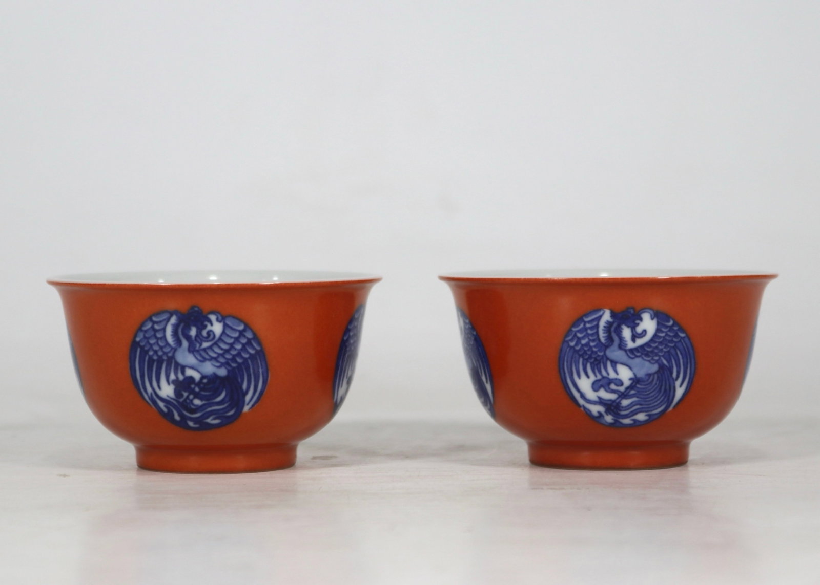 A Pair of Exquisite Iron-Red Blue and White Phoenix Pattern Cups: A Pair of Exquisite Iron-Red Blue and White Phoenix Pattern Cups,Qing Dynasty,China,Yongzheng Six-character Mark,Size:3.1inx1.8in