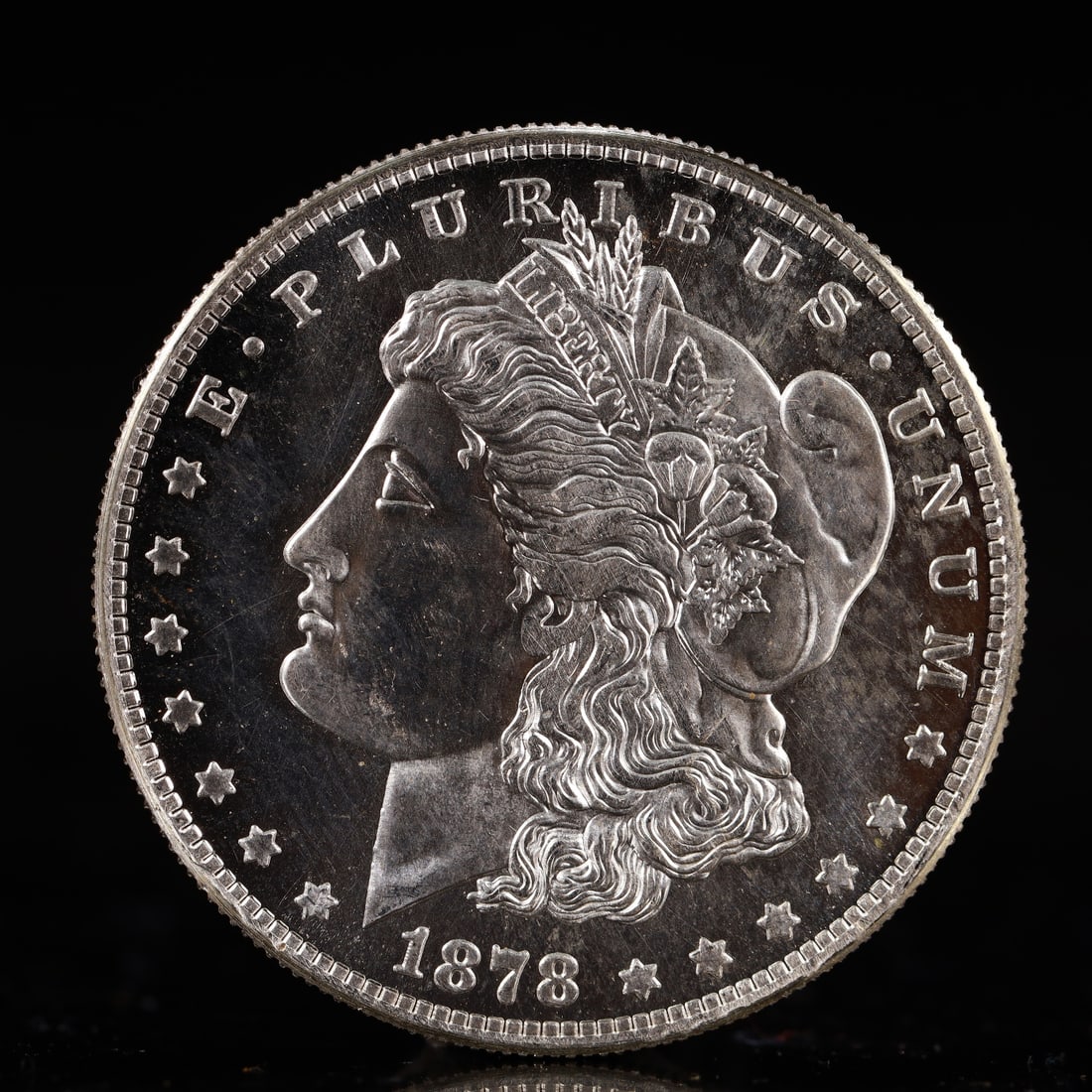 USA Morgan Dollar 1878 Coin: Obv: profile bust with date below and E PLURIBUS UNUM legend and stars around. Rev: eagle with In God we trust above within wreath with UNITED STATES OF AMERICA ONE DOLLAR legend. IN GOD WE TRUST / LI