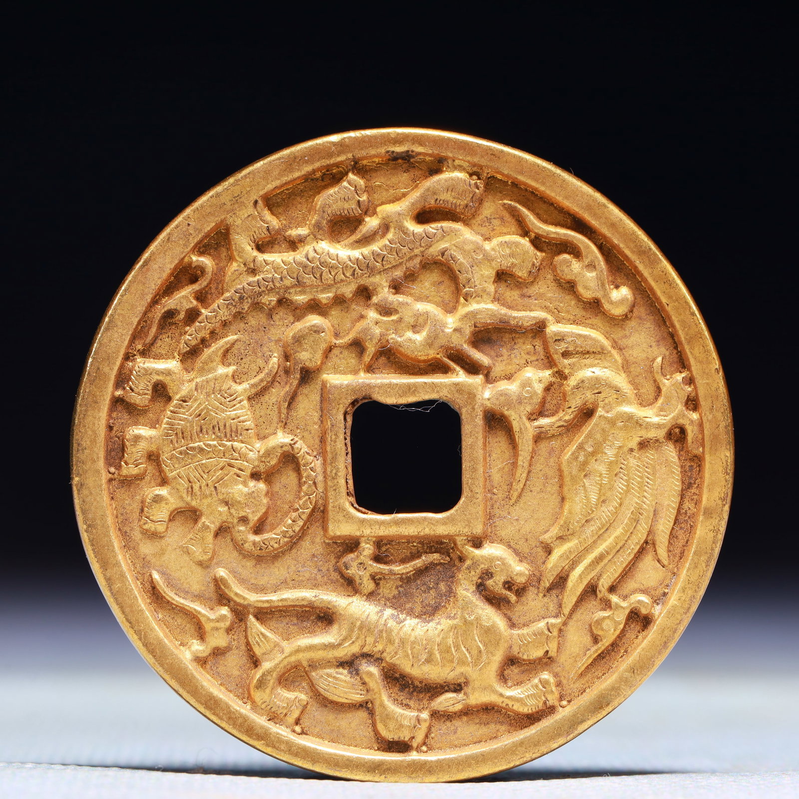 An Exquisite Gilt Bronze Auspicious Beast Pattern Cash Coin: An Exquisite Gilt Bronze Auspicious Beast Pattern Cash Coin,the Liao and Jin dynasties in China,Size:2in,Weight:36.9g 铜鎏金瑞兽纹钱币,中国&