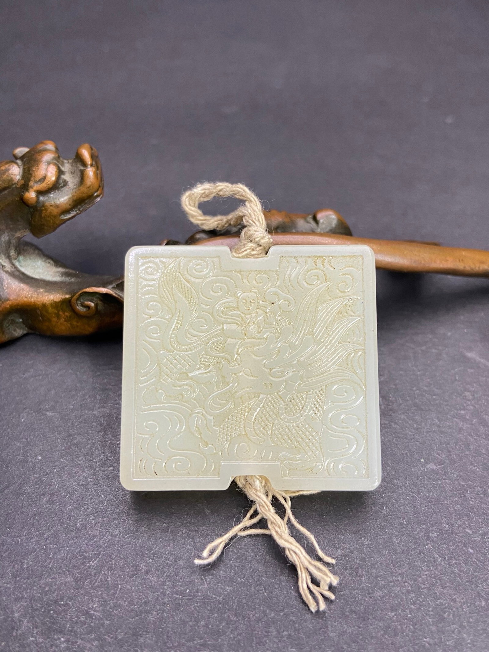 An Exquisite White Jade Auspicious Cloud,Figure and Dragon Pattern Pendant: An Exquisite White Jade Auspicious Cloud,Figure and Dragon Pattern Pendant,Qing Dynasty,China,Size:1.4inx1.5inx0.3in,Weight:31g 白玉祥云人物龙纹挂