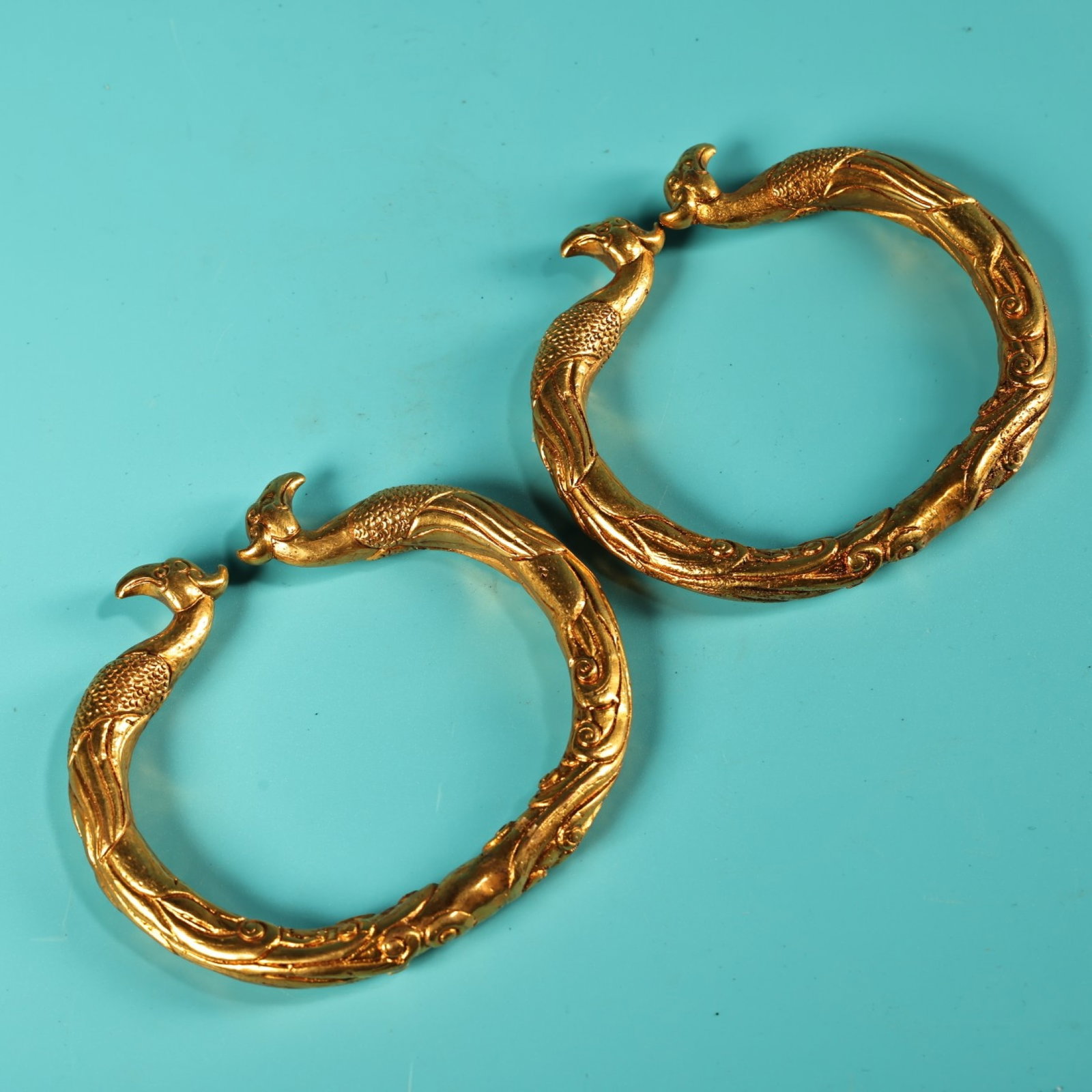 A Pair of Exquisite Gilt Bronze Phoenix Pattern Bracelets: A Pair of Exquisite Gilt Bronze Phoenix Pattern Bracelets,Qing Dynasty,China,Size:2.8in,Weight:260g 一对铜鎏金凤纹手镯,中国清