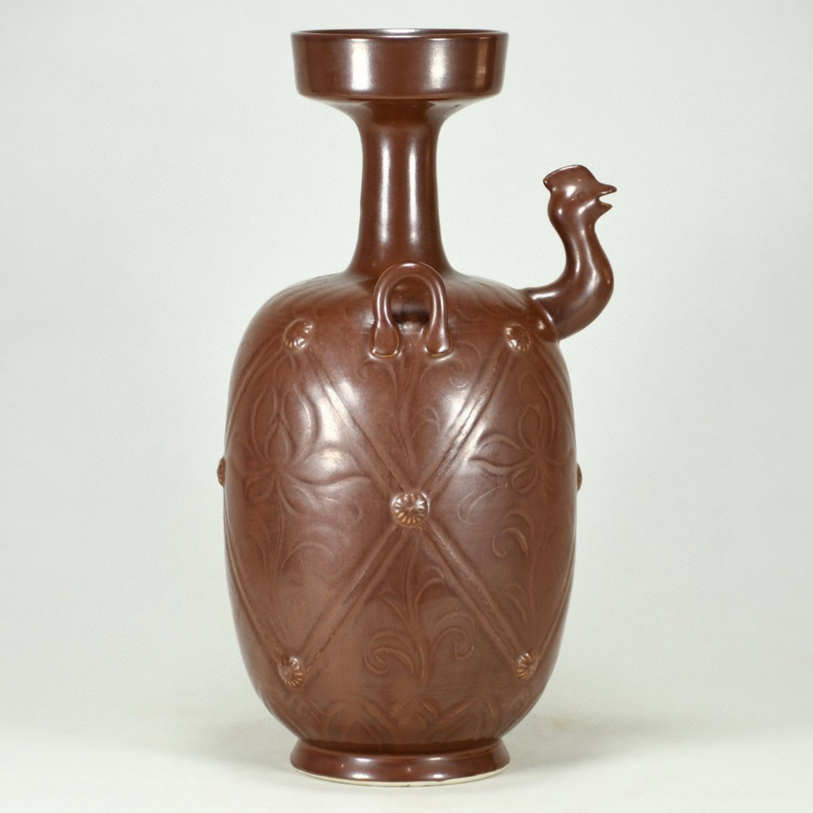 An Exquisite Purplish Gold Glazed Flower Pattern Phoenix-head Double-Ears Ewer: An Exquisite Purplish Gold Glazed Flower Pattern Phoenix-head Double-Ears Ewer,Song Dynasty,China,Size:11.4inx6.7in 紫金釉花卉纹凤首双耳