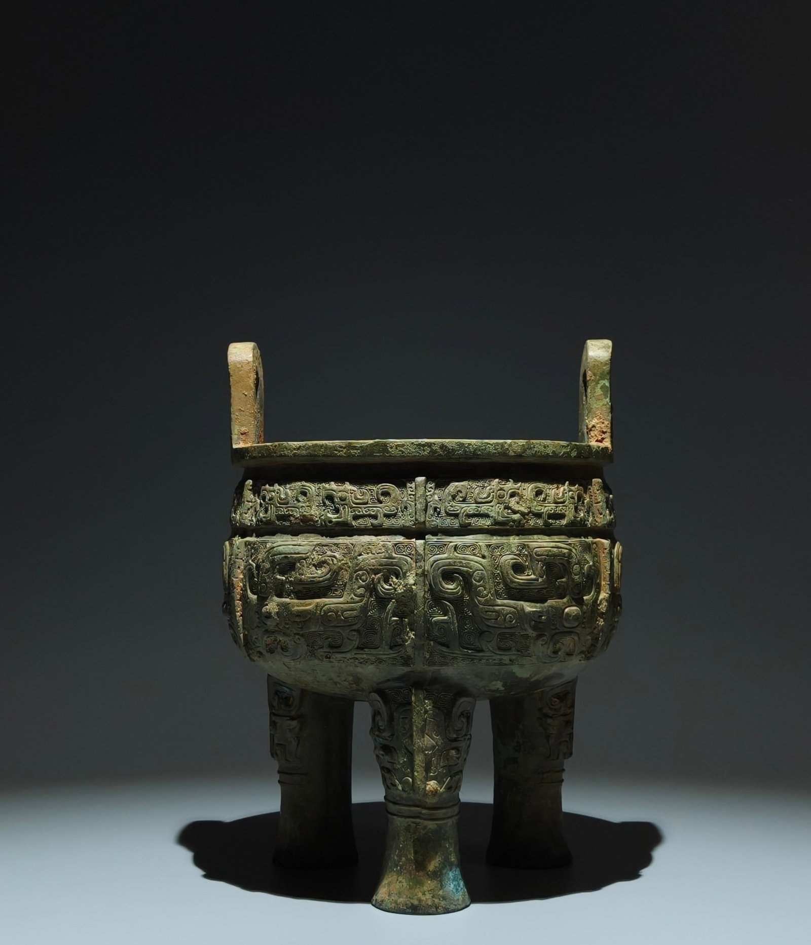 An Archaic Bronze Beast-Face Pattern Double-Ears Tripod Censer: An Archaic Bronze Beast-Face Pattern Double-Ears Tripod Censer,Shang Dynasty,China,Size:10.8inx7.9in 青铜兽面纹双耳三足香炉,中&#