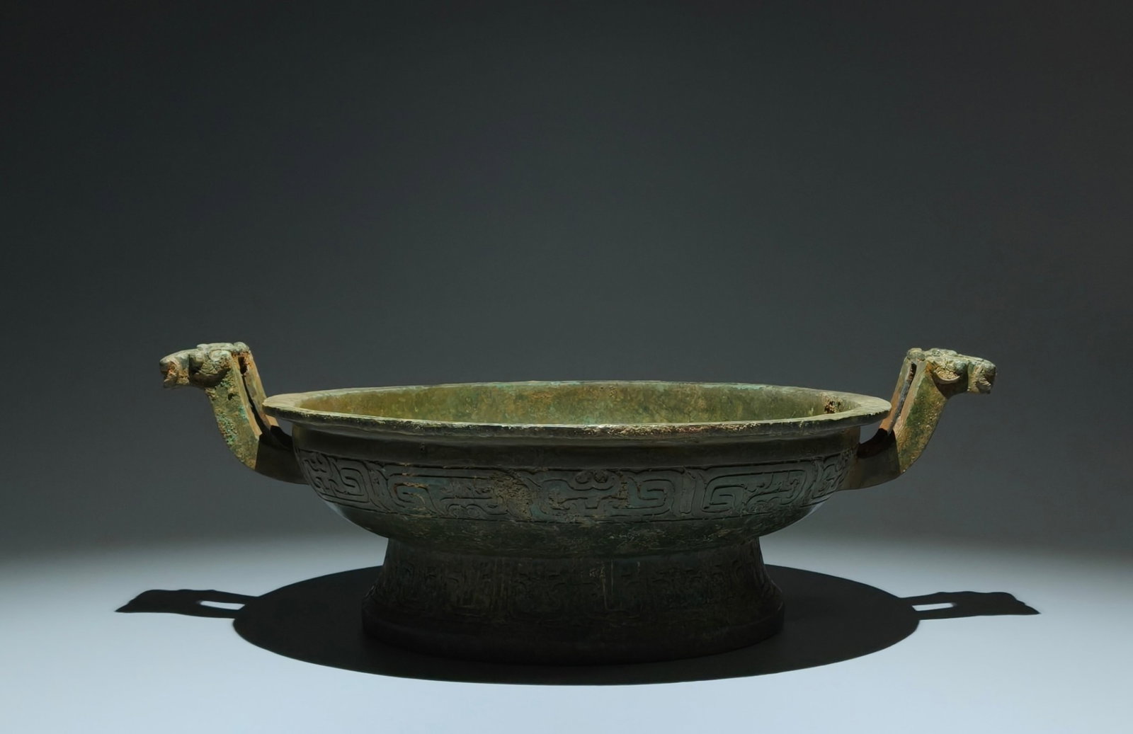 An Archaic Bronze Beast-Ears Plate,With Inscription: An Archaic Bronze Beast-Ears Plate,With Inscription,W.Zhou,China,Size:5.5inx16.5inx12.6in 青铜兽耳盘,带铭文,中国西周时
