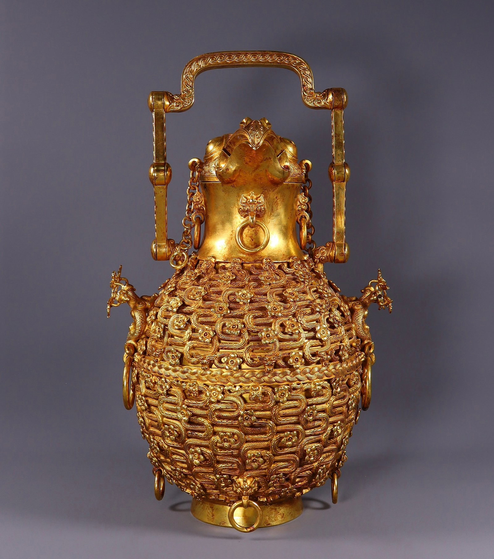 A Rare Gilt Bronze Hollow Flower Pattern Bird-head Beast-Ears Ewer: A Rare Gilt Bronze Hollow Flower Pattern Bird-head Beast-Ears Ewer,Qing Dynasty,China,Size:12.2inx7.9inx7.1in,Weight:4804g 铜鎏金镂空花卉纹鸟Ɖ