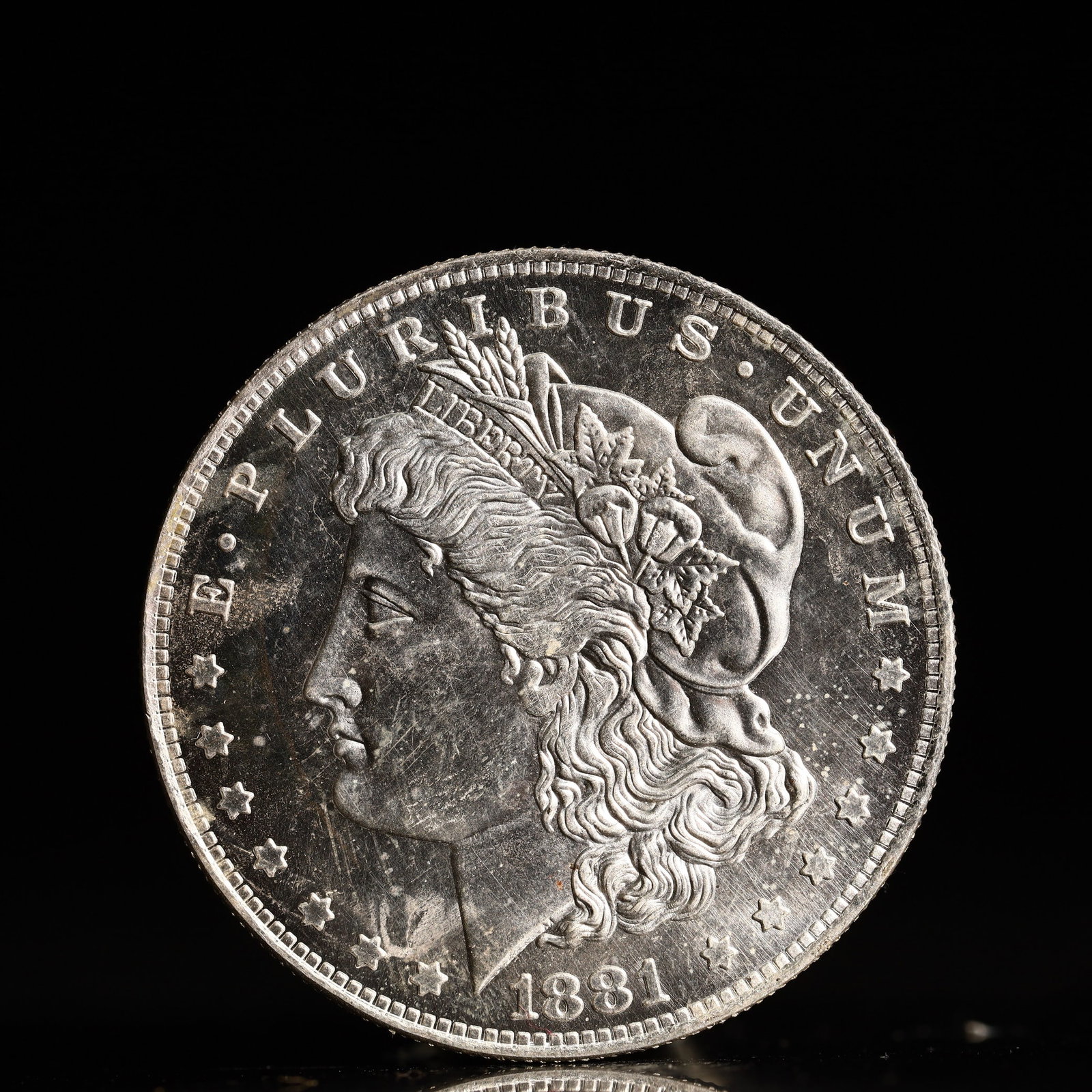 USA Morgan Dollar 1881 Coin: Obv: profile bust with date below and E PLURIBUS UNUM legend and stars around. Rev: eagle with In God we trust above within wreath with UNITED STATES OF AMERICA ONE DOLLAR legend. IN GOD WE TRUST / LI
