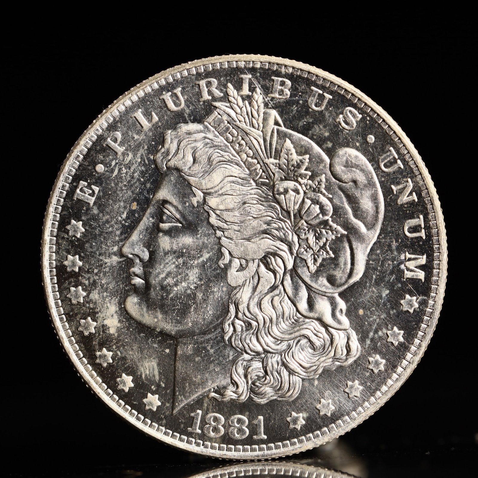 USA Morgan Dollar 1881 Coin: Obv: profile bust with date below and E PLURIBUS UNUM legend and stars around. Rev: eagle with In God we trust above within wreath with UNITED STATES OF AMERICA ONE DOLLAR legend. IN GOD WE TRUST / LI