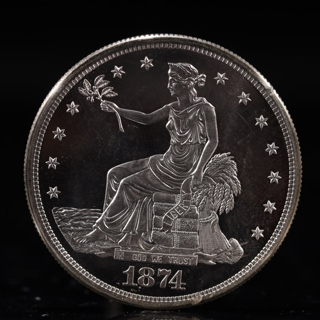 USA Trade Dollar 1874 Coin: American coin. Obverse: Liberty seated on a pedestal facing the sea to the left holding olive branches surrounded by 13 stars. IN GOD WE TRUST / LIBERTY / 1874. Reverse: An eagle holding branches with
